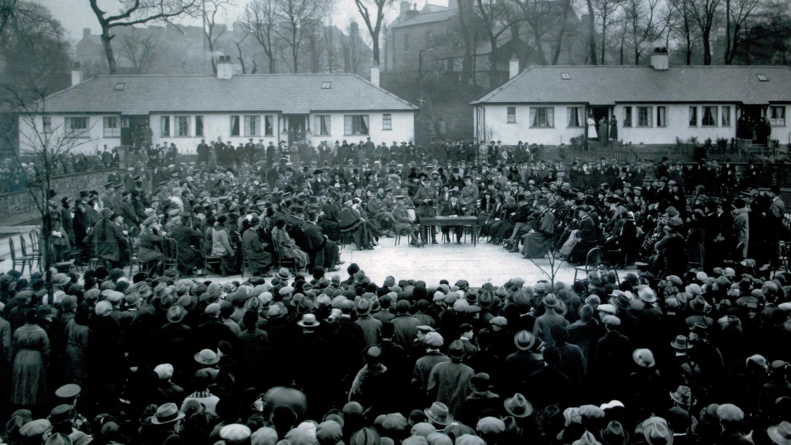 The original black and white photograph of Earl Douglas Haig officially opening the Westfield War Memorial Village. Haig is standing in the centre of the village bowling green surrounded by local dignitaries and crowds of people. 