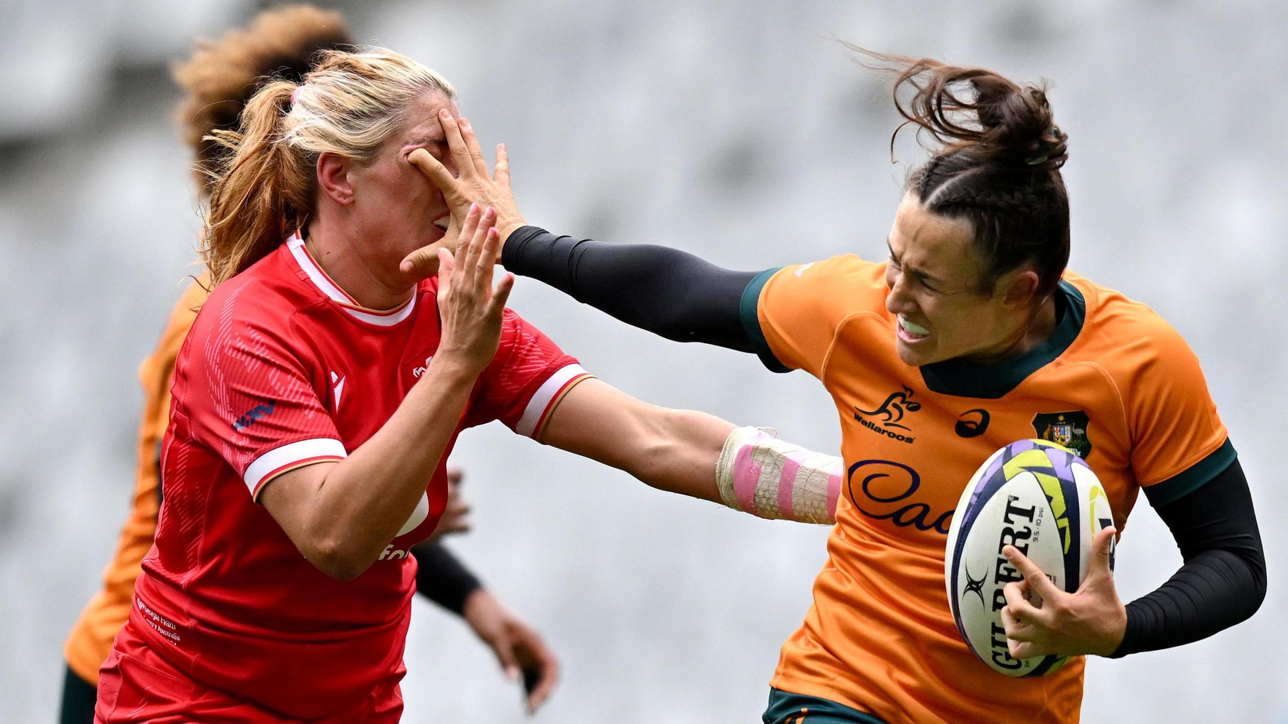 Caitlyn Halse of Australia hands off Georgia Evans of Wales