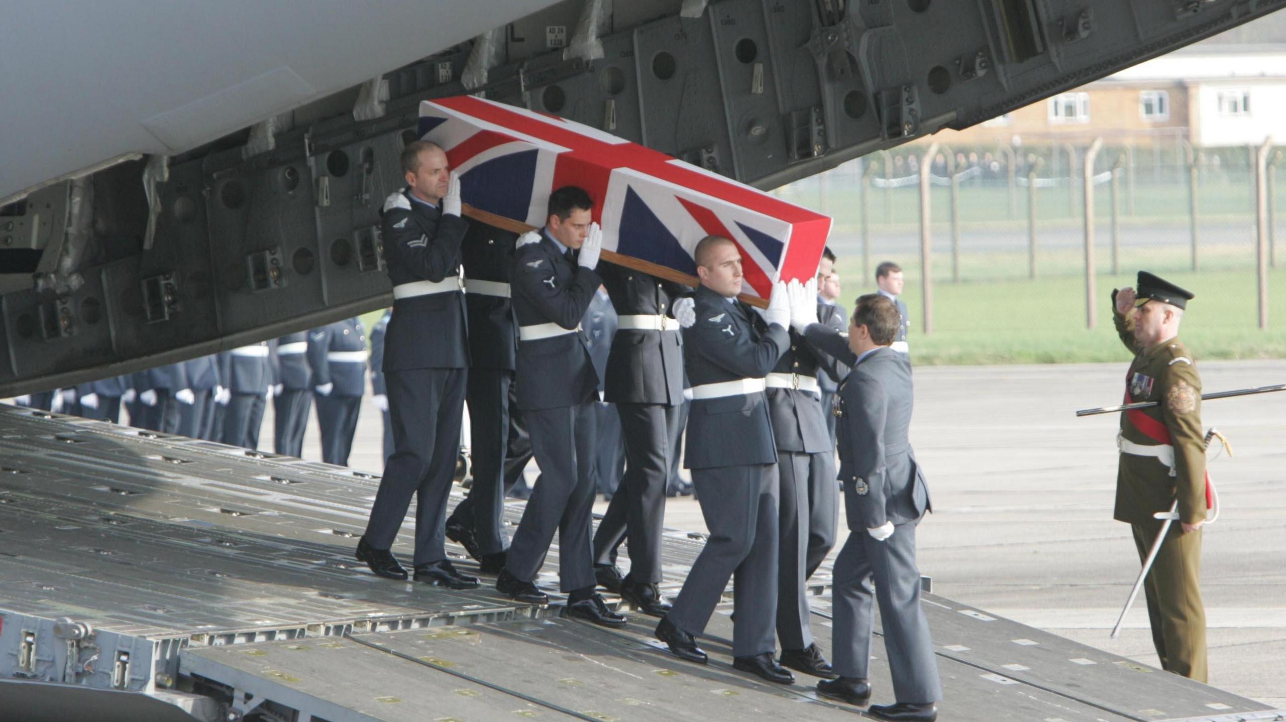 The coffin of Squadron Leader Patrick Marshall, who was one of ten servicemen killed when the C130 Hercules plane they were travelling in crashed in Iraq 30/1/2005, is returned to the UK at RAF Lyneham in Wiltshire, Tuesday February 8, 2005. 