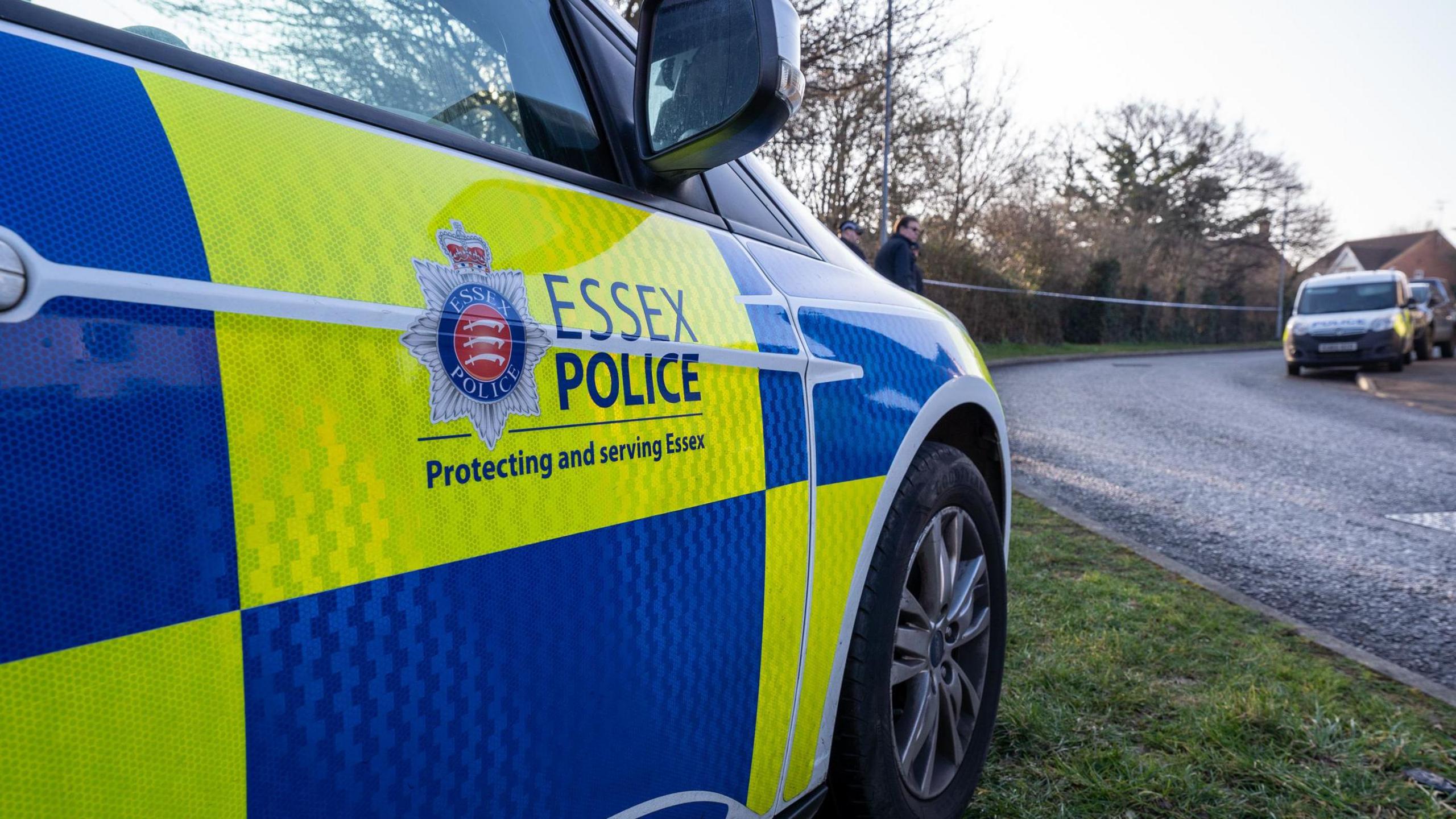 Essex Police branded police car facing a road.