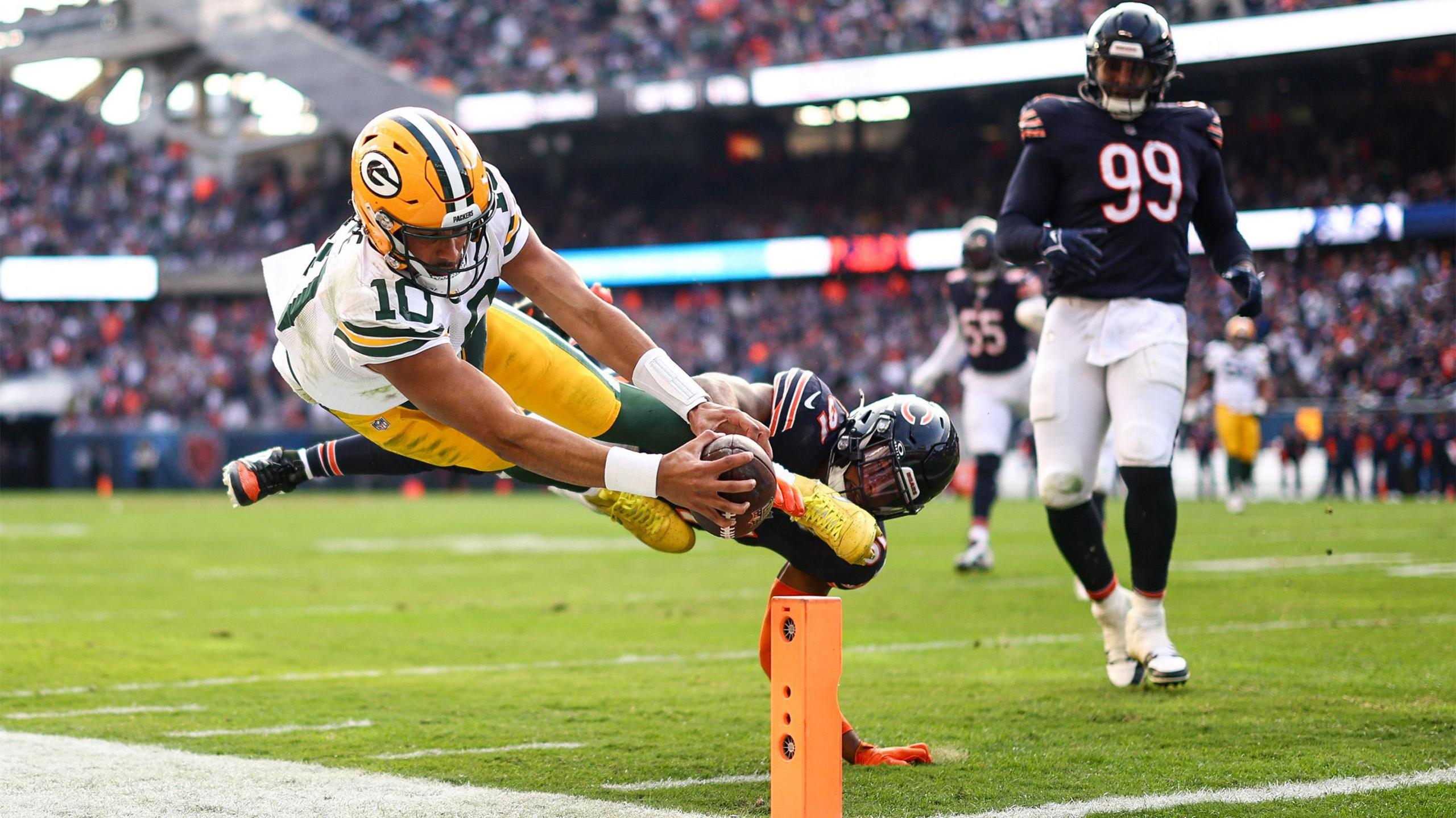 Green Bay Packers quarterback Jordan Love dives at the pylon with the ball during the second half of an NFL football game against the Chicago Bears, Sunday, Nov. 17, 2024 in Chicago, Illinois.
 