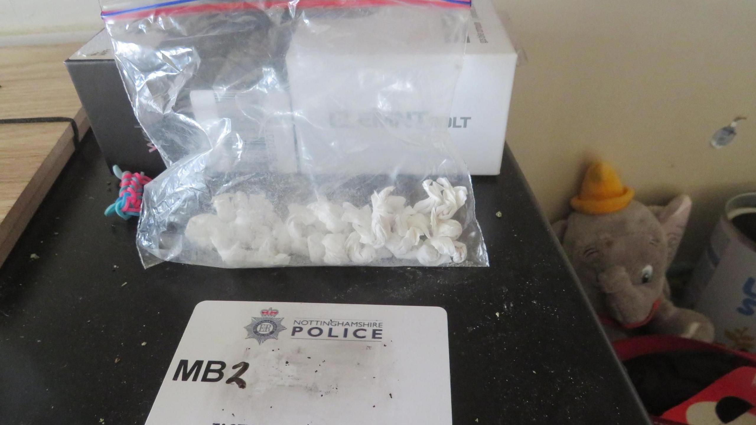 A bag of small white wraps in a clear plastic pouch, which sits on a black flat surface.