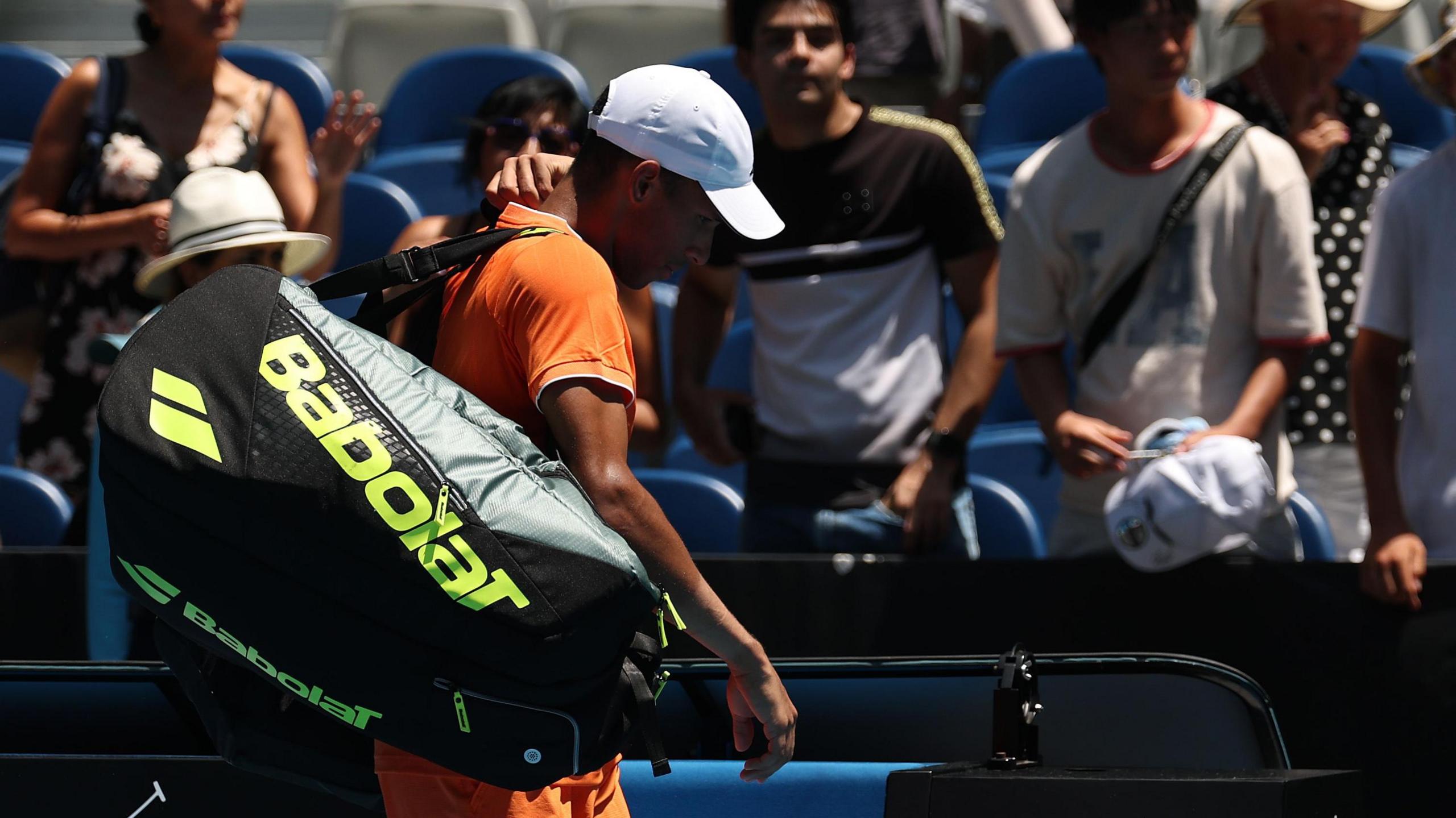 Felix Auger-Aliassime walks off court at the Australian Open