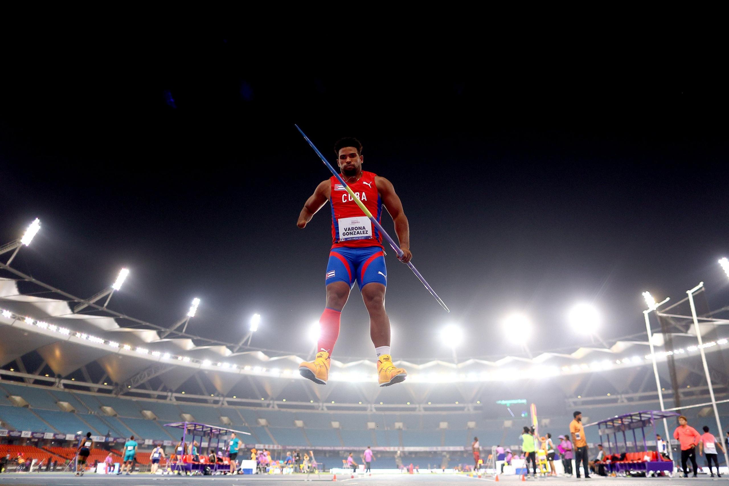 Cuba's Guillermo Varona Gonzalez jumps in the air before preparing to throw in the javelin F46 final at the World Para Athletics Championships in New Delhi, India