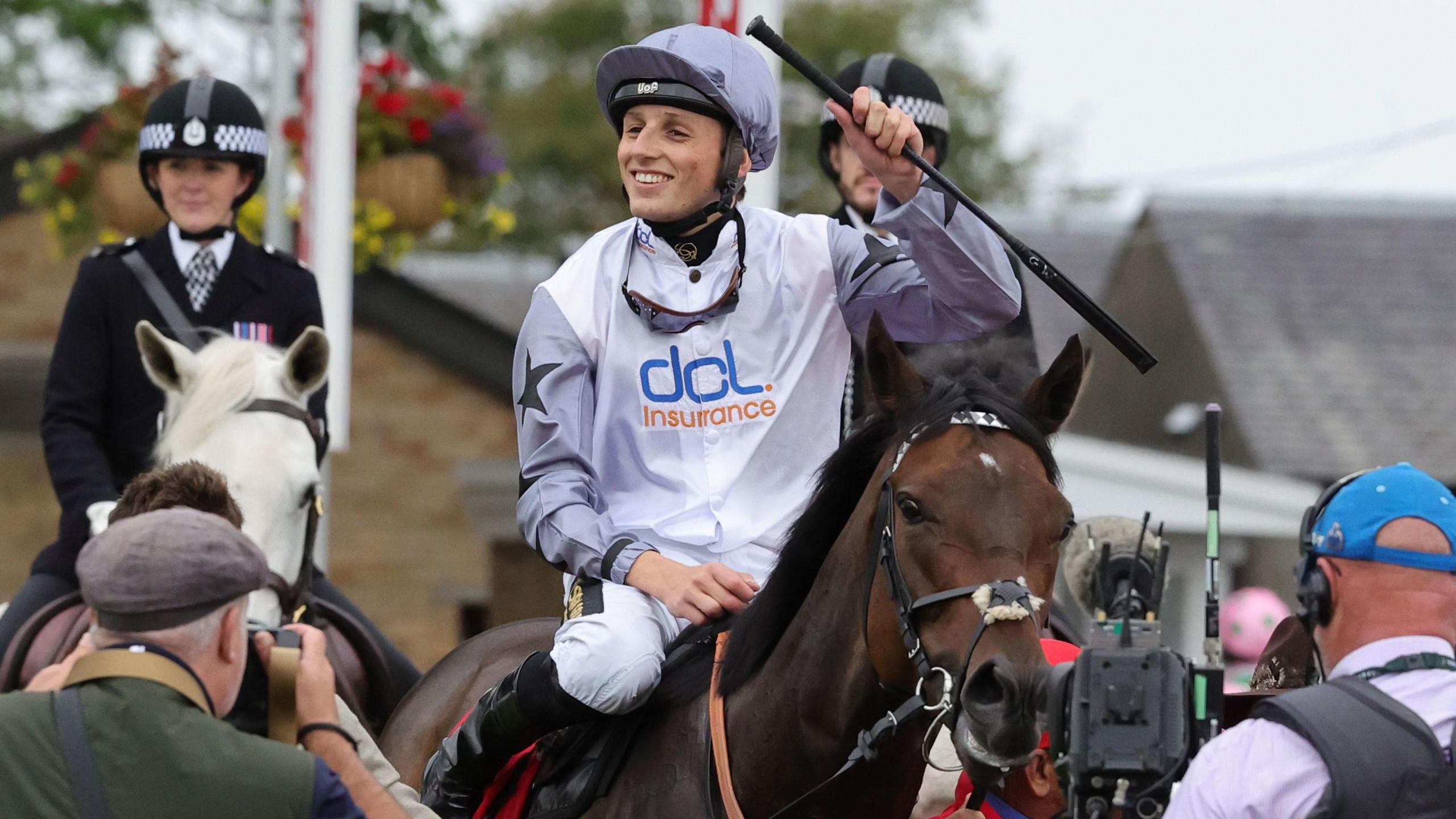 Jockey George Wood celebrates aboard horse Run Boy Run after his Ayr Gold Cup triumph.