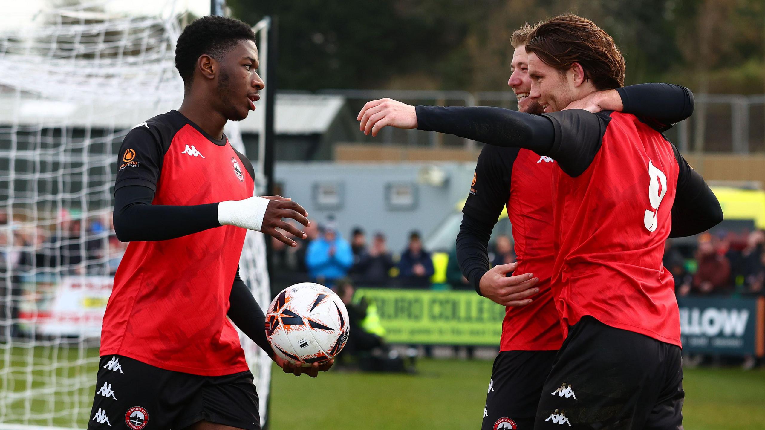 Truro City players celebrate a goal