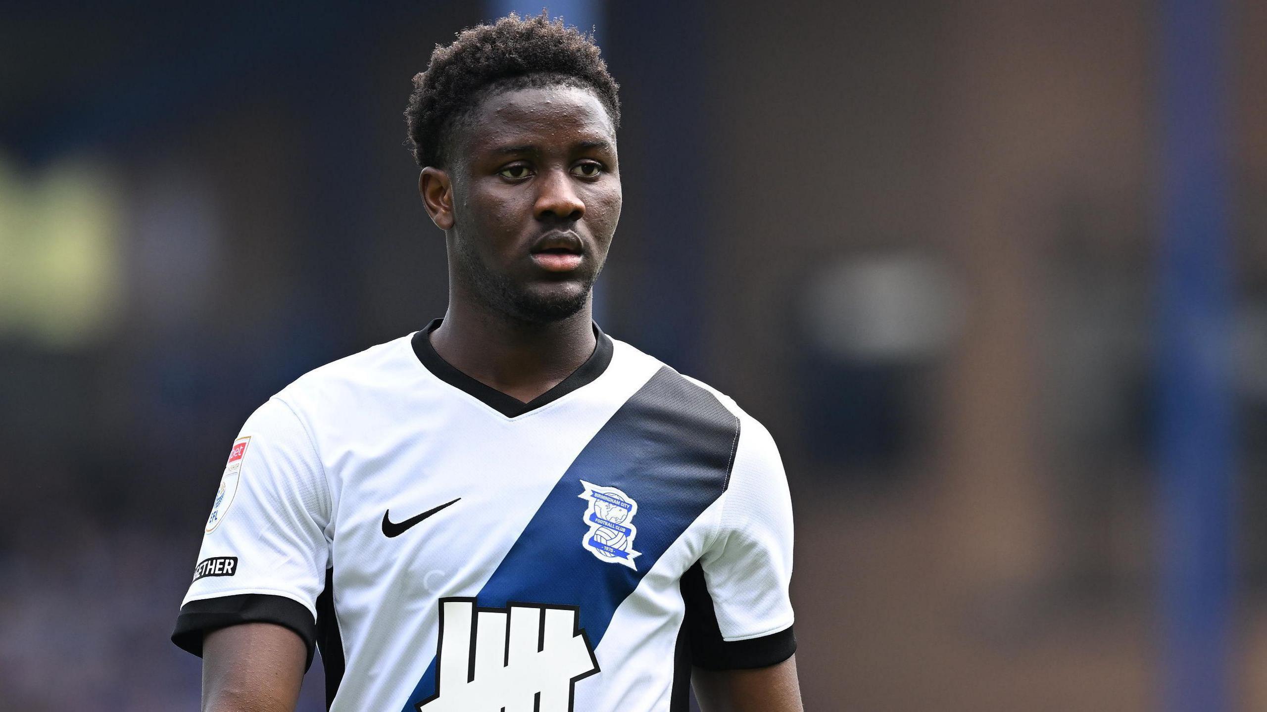 Ibrahim Osman in action for Birmingham City. He is wearing a white away shirt with a dark blue sash.