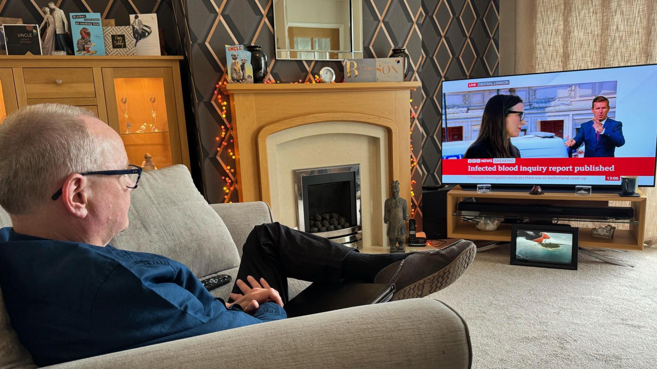 Stuart Hall watching the report's findings being announced at his home on Monday