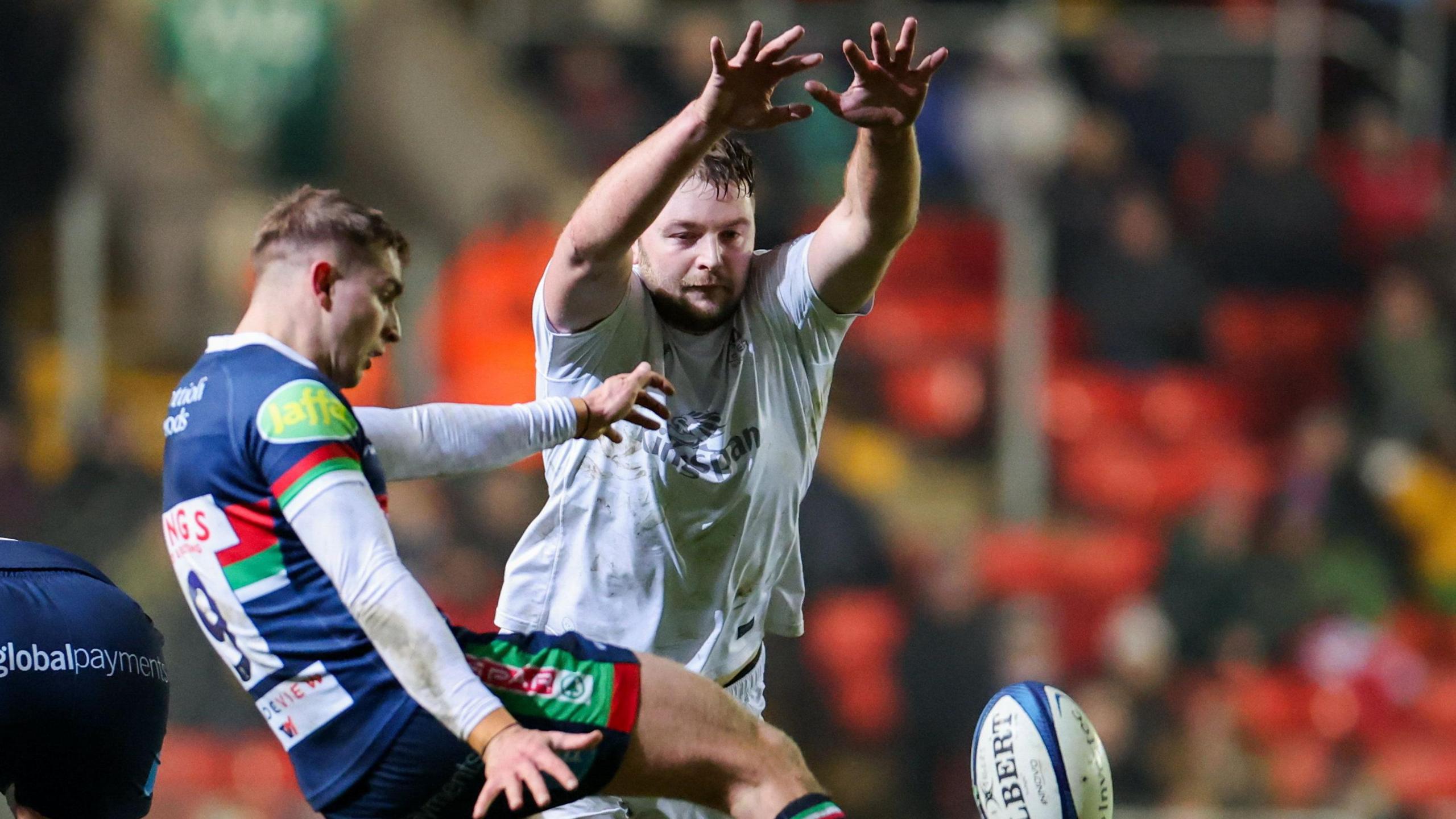 Iain Henderson charges down a kick 