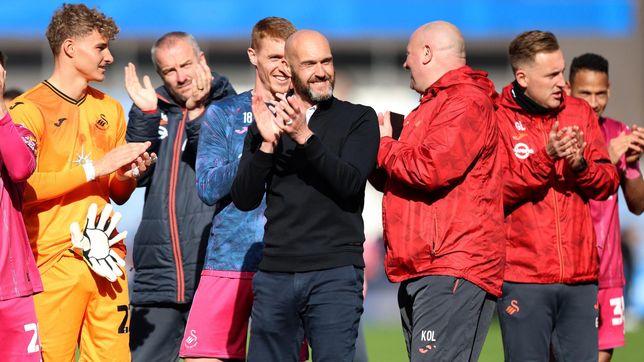 Luke Williams leads applause to Swansea's fans after the win at Huddersfield in April