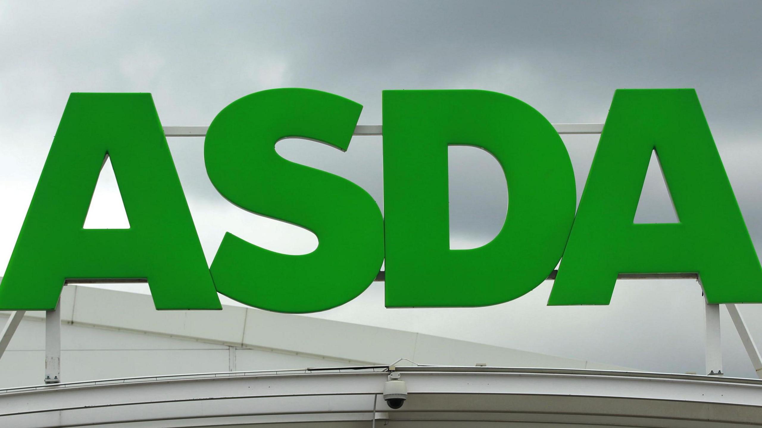 A green Asda sign fixed above a store.