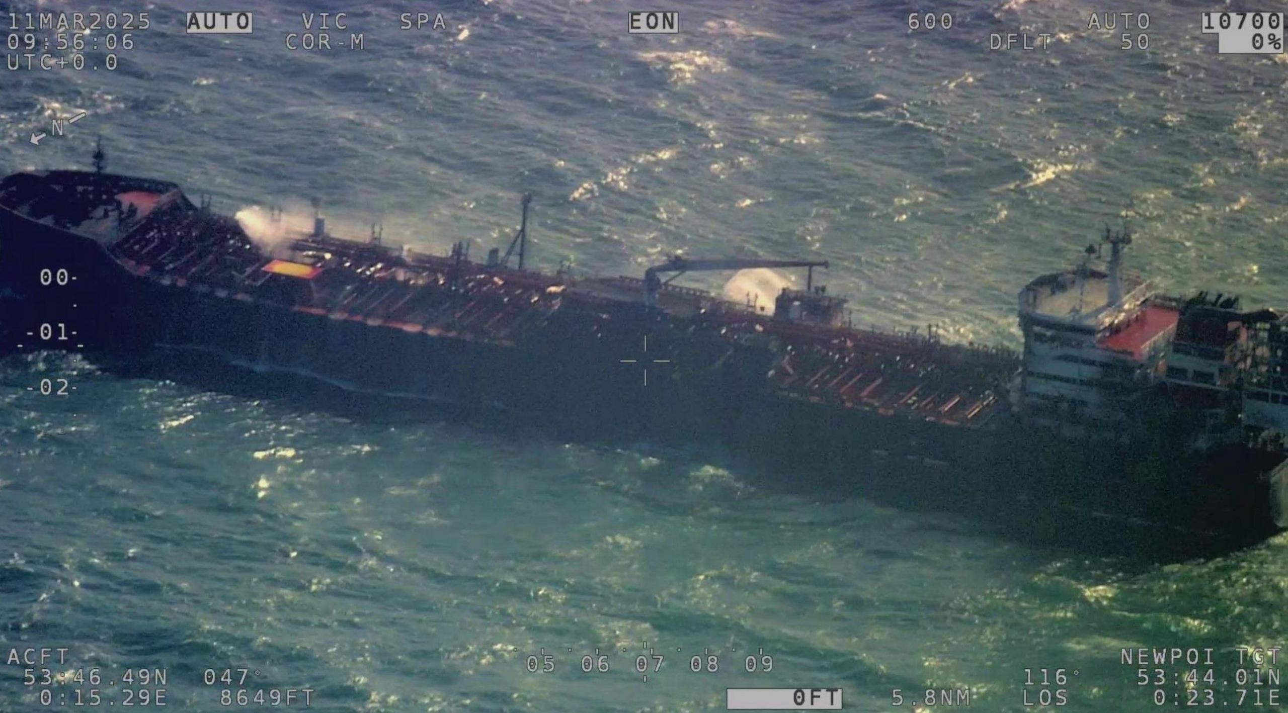 Aerial view of the Stena Immaculate, a large container vessel, anchored in a choppy blue sea.