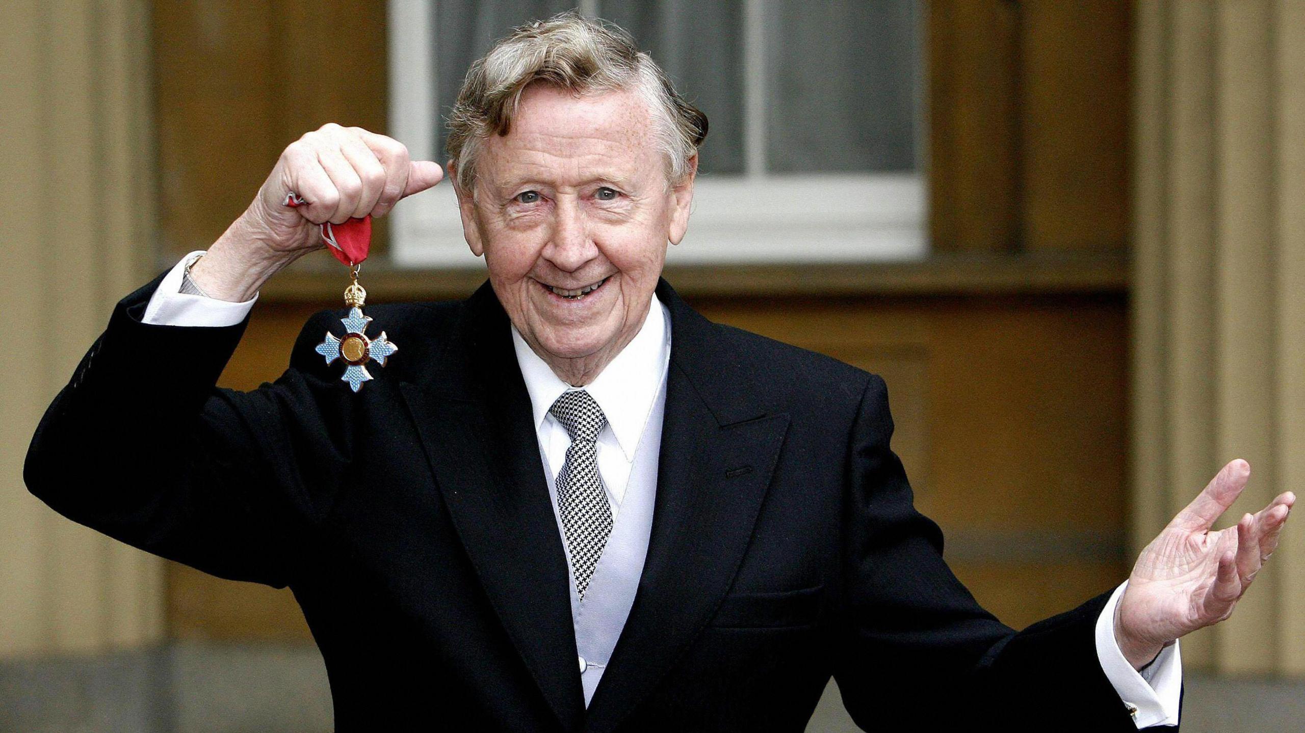 Bernard Atha poses after receiving his Commander of the British Empire (CBE) from the Prince of Wales at Buckingham Palace in London, 25 October 2007.