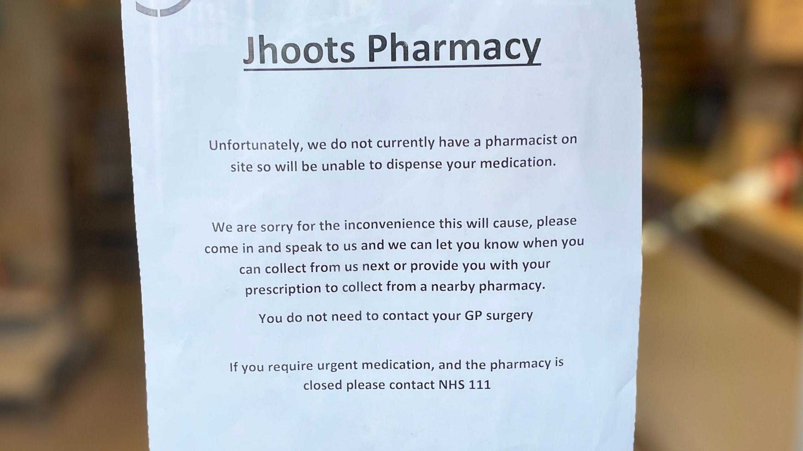 A notice in a shop window with a written statement from Jhoots Pharmacy.