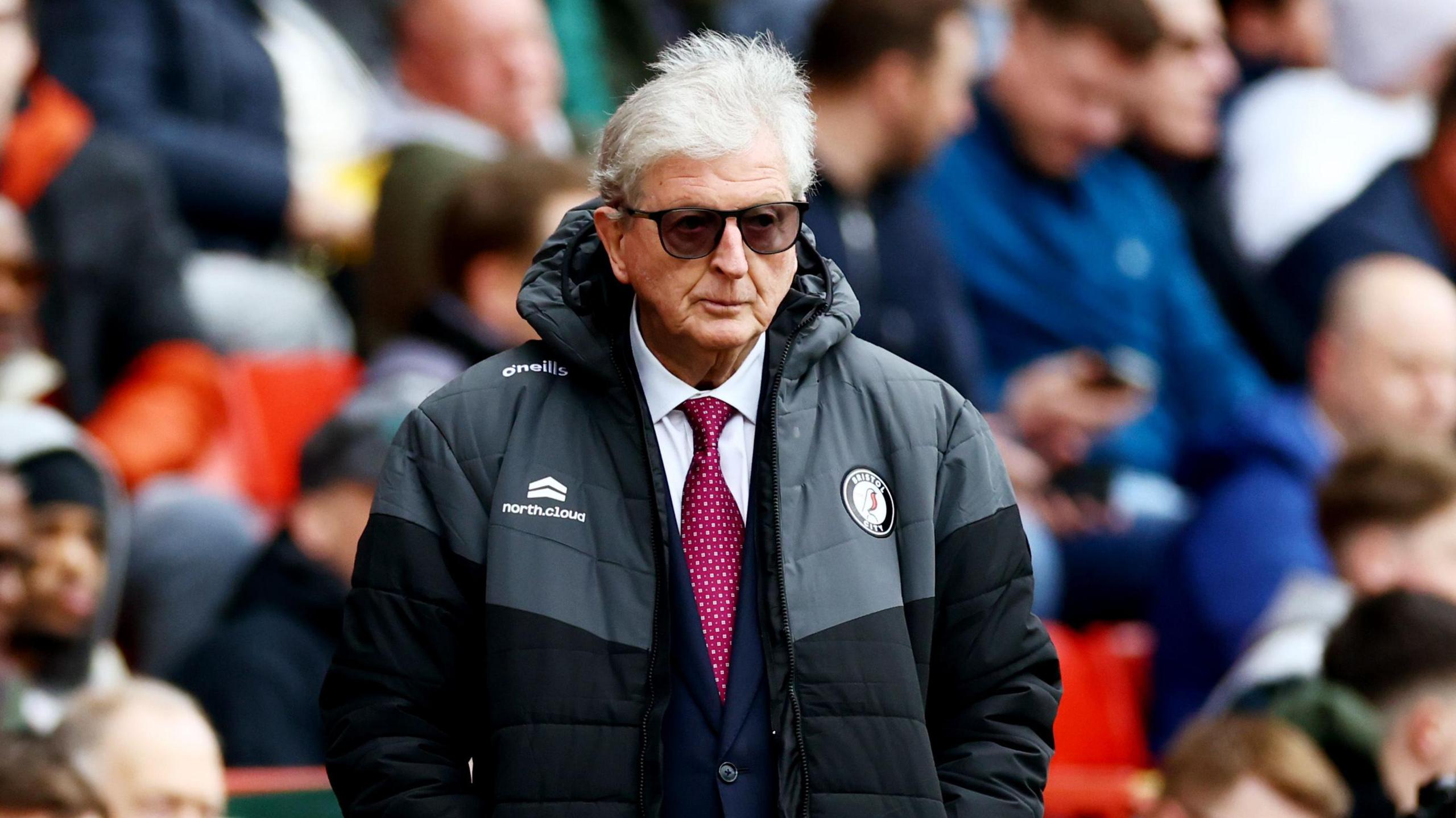 Roy Hodgson watches Bristol City with his hands in his coat pocket and a pair of dark sunglasses on