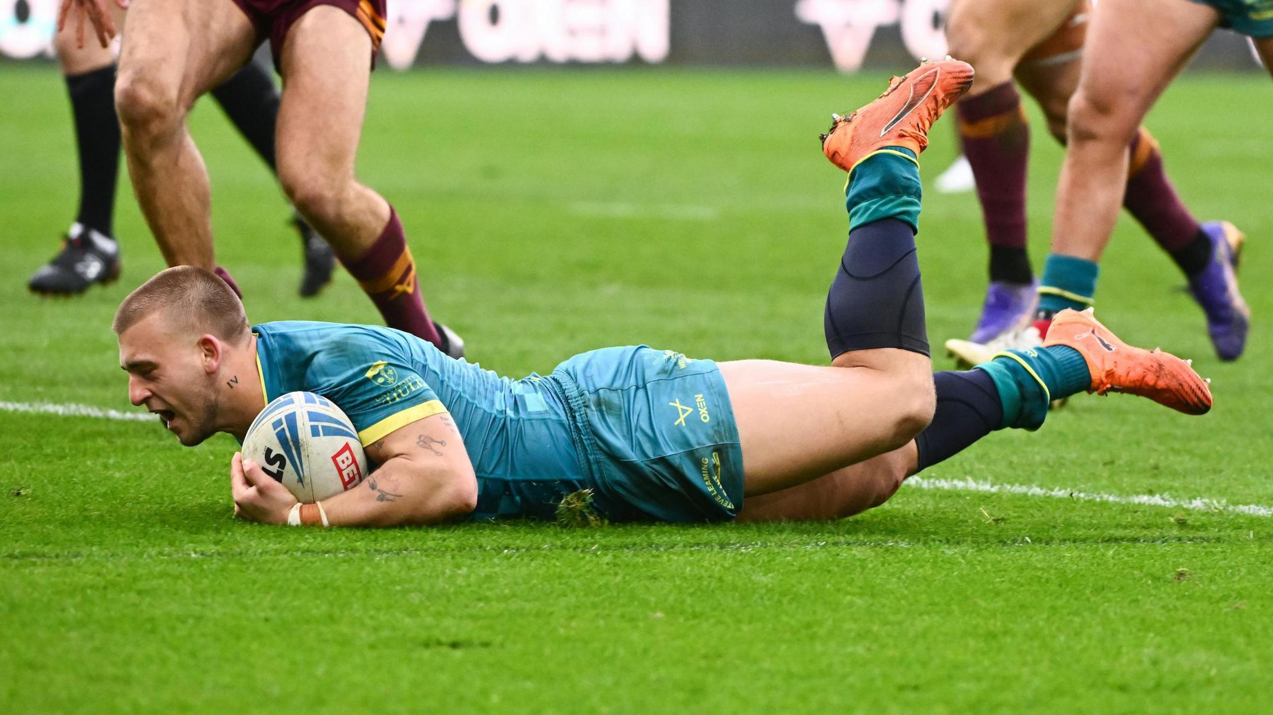 Hull KR stand-off Mikey Lewis, with the ball under his left arm, sliding over the line for a try 