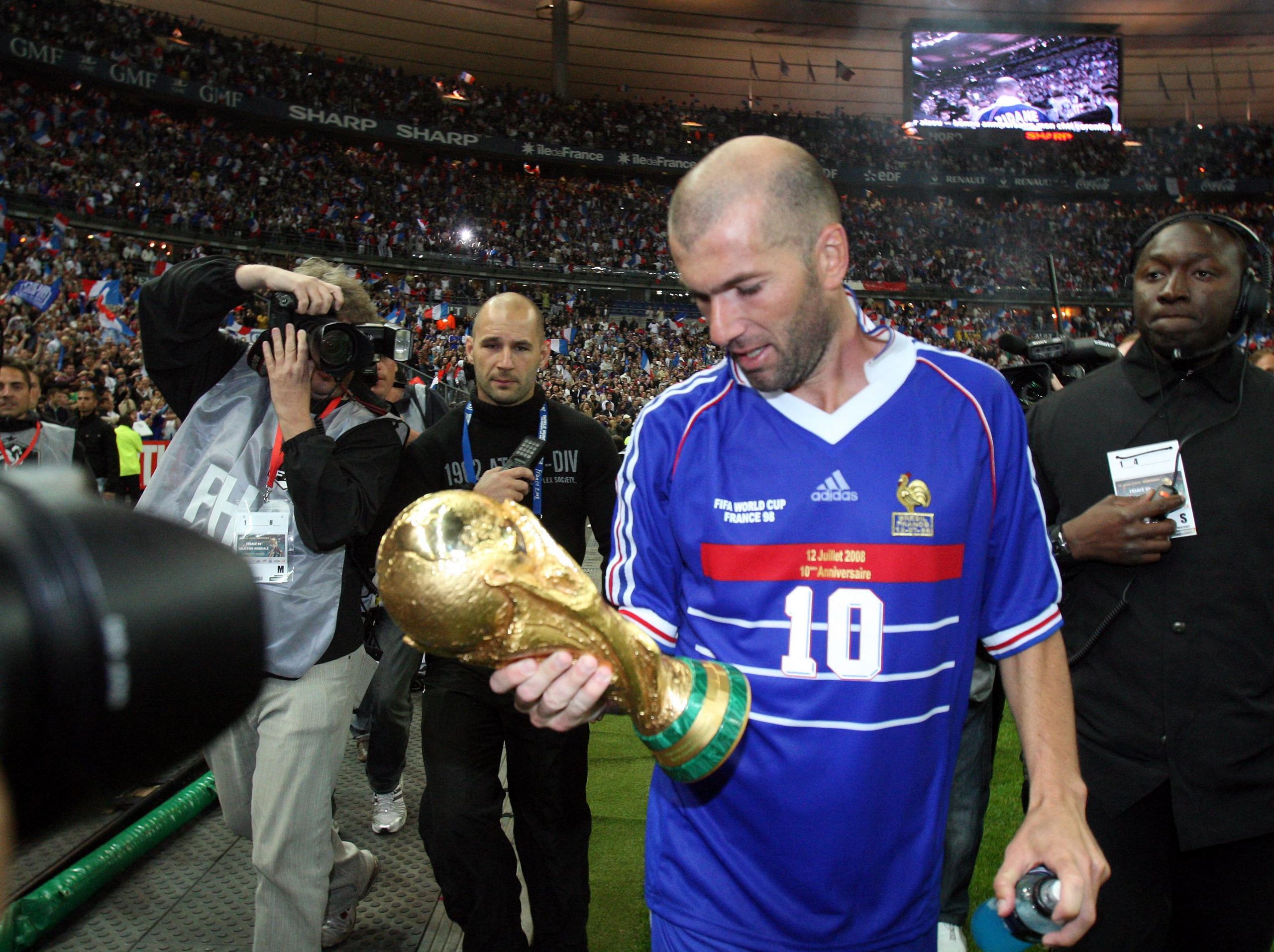 Zidane holds World Cup trophy after victory in 1998