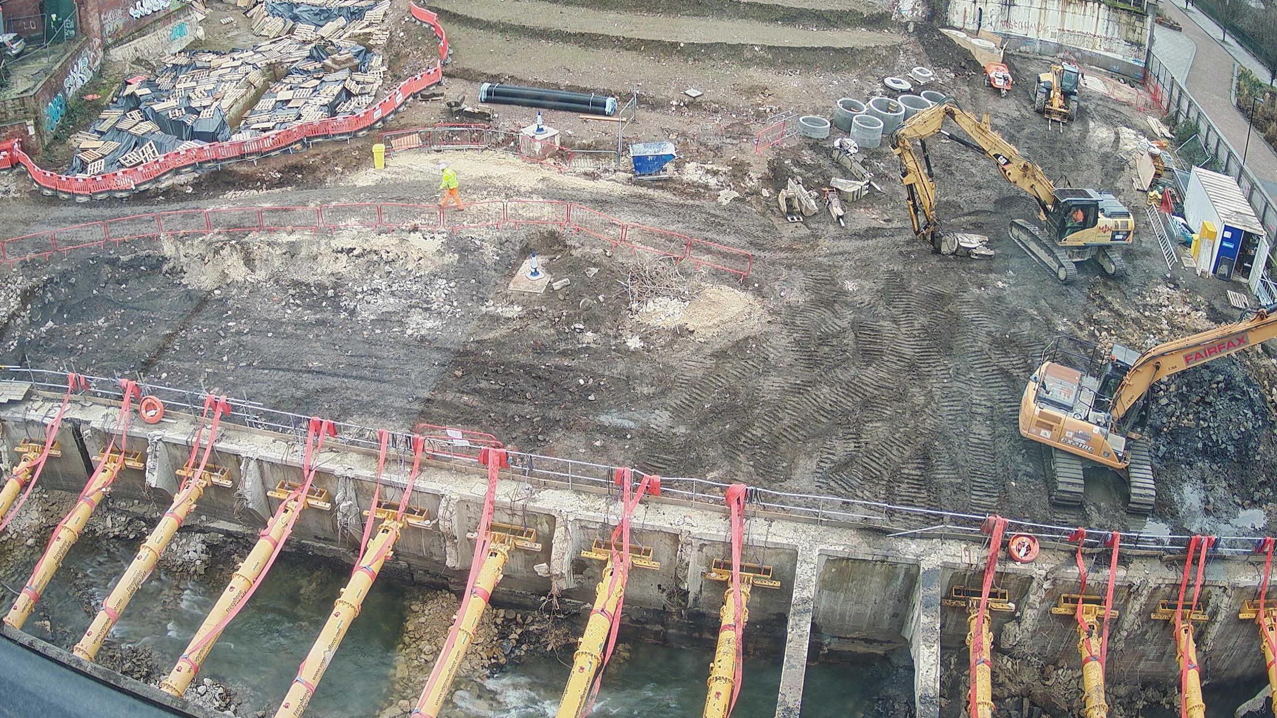 An aerial view of a construction site with two large diggers.