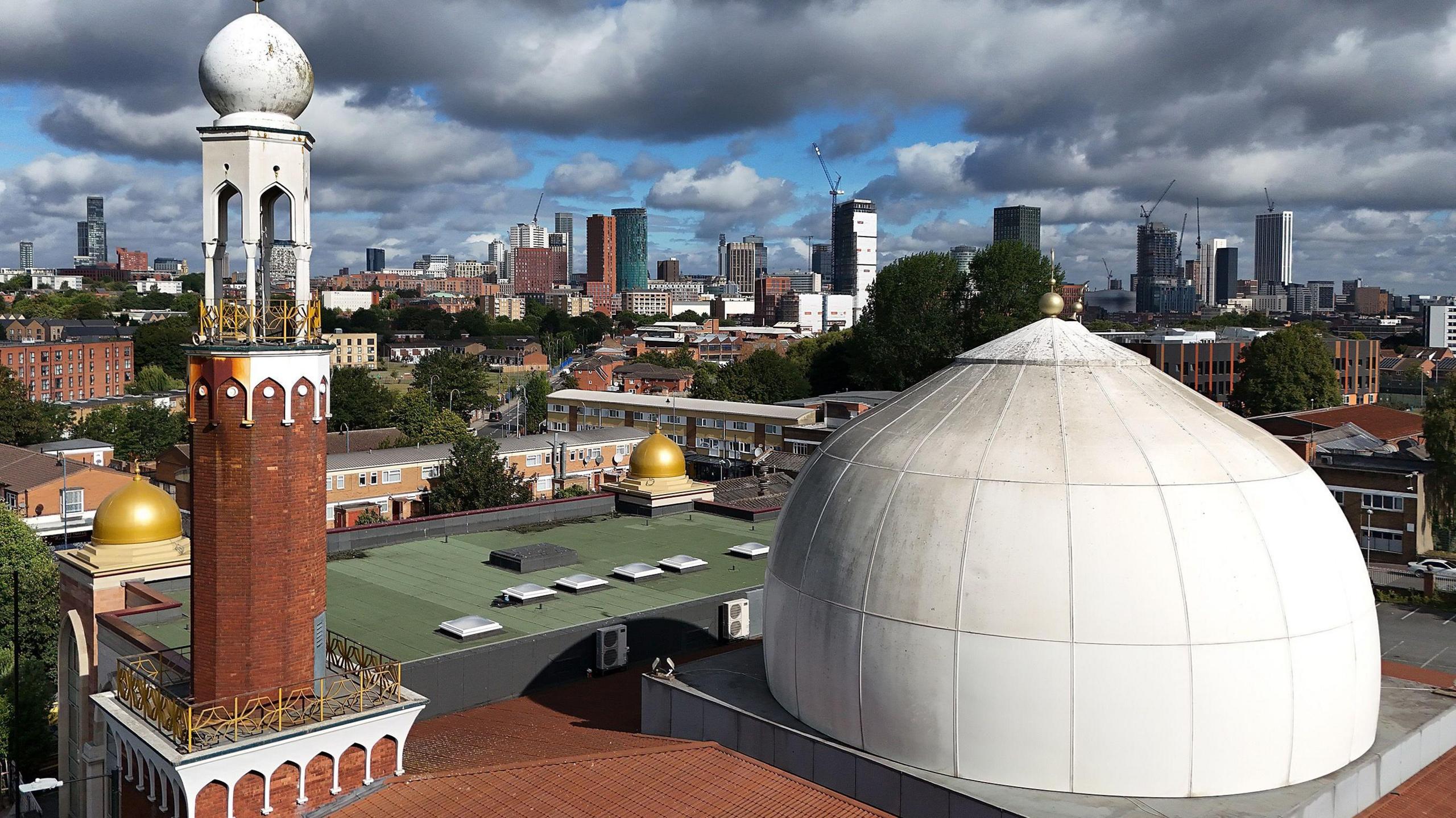 Aerial photograph of Birmingham's central mosque with a distinctive white dome and red brick minaret