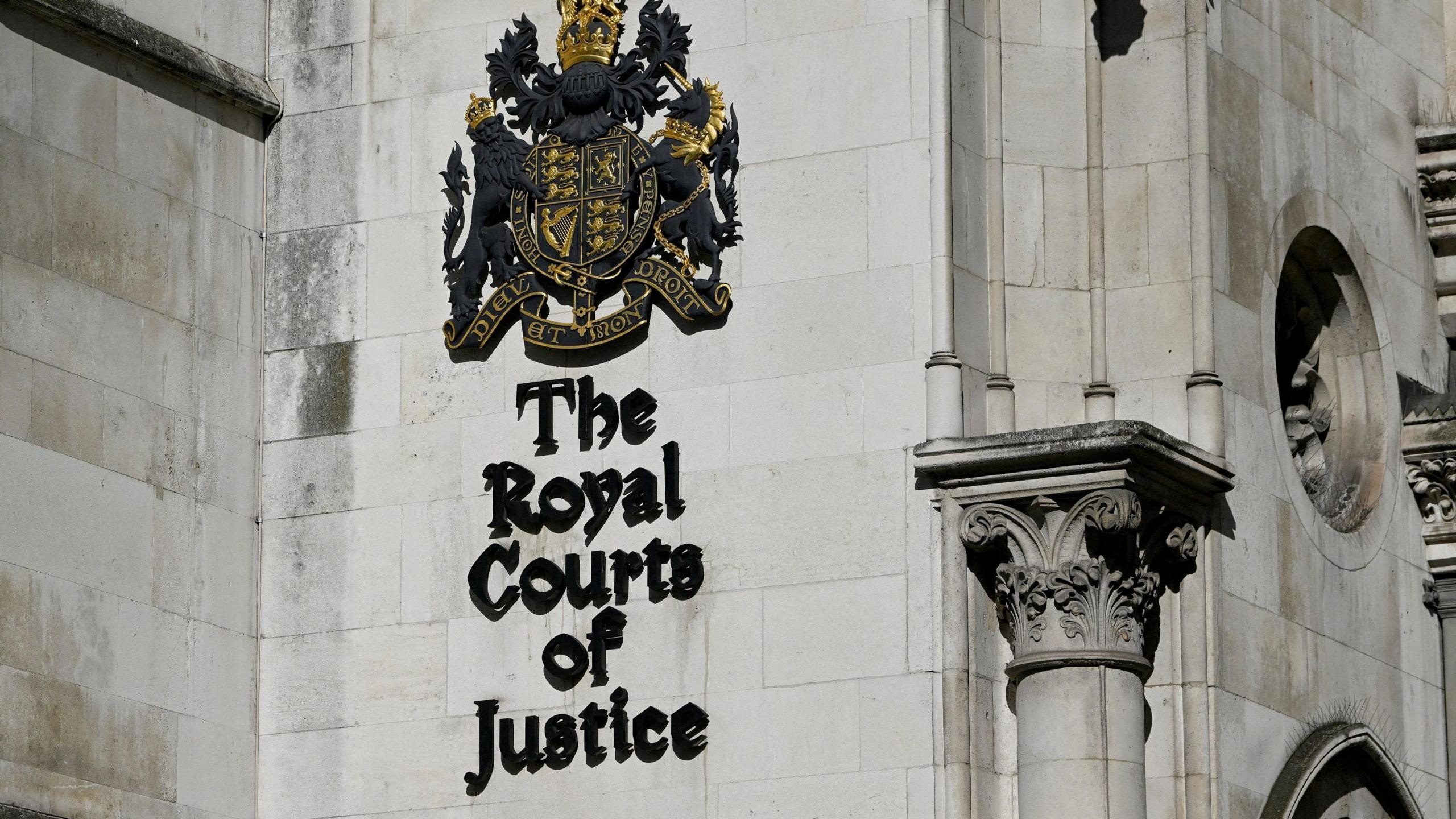 Signage at the High Court in London on the stone side of the building.