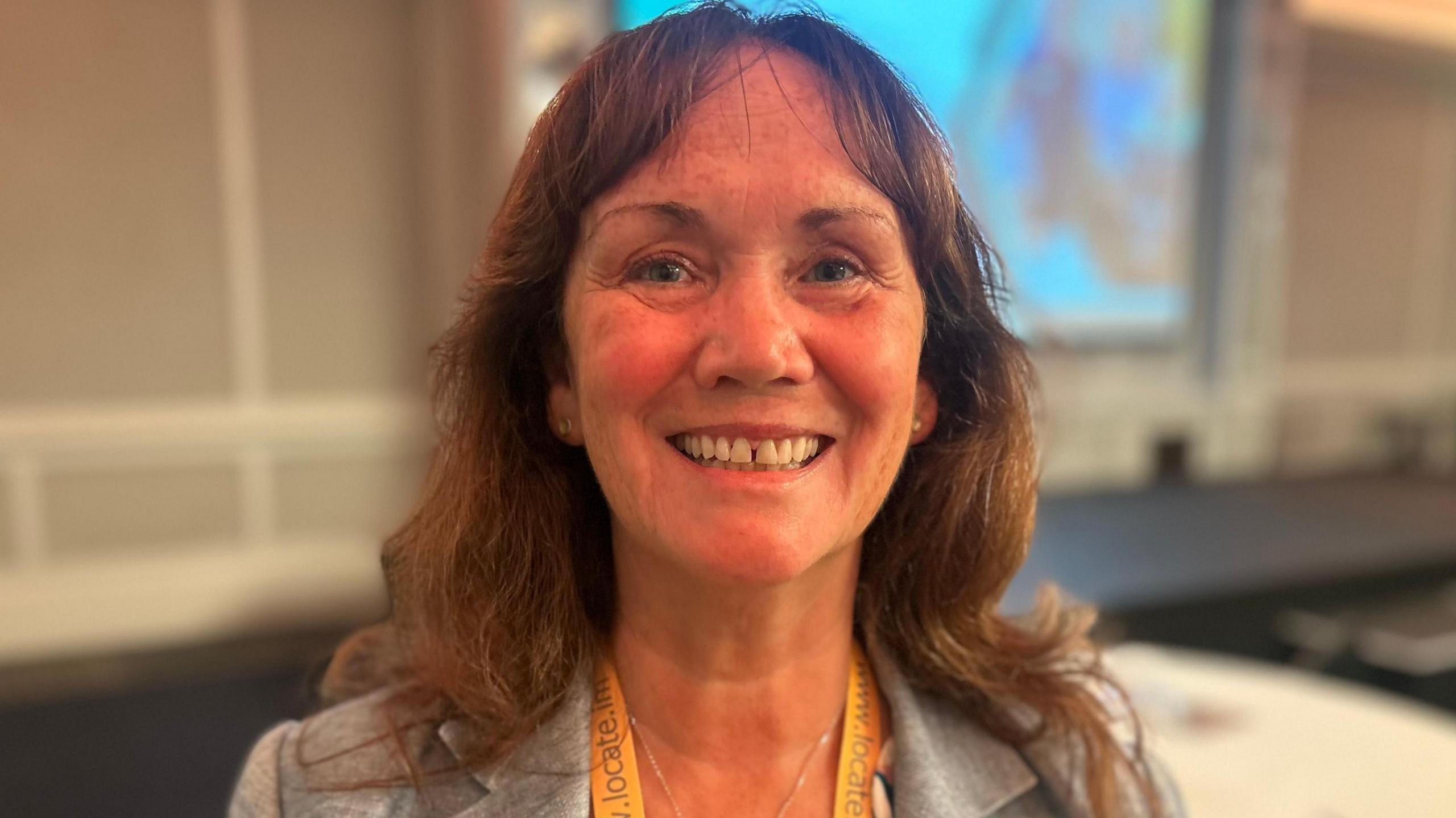 Diane Kelsey MLC smiles at the conference. She has long brown hair and wears a grey suit jacket.