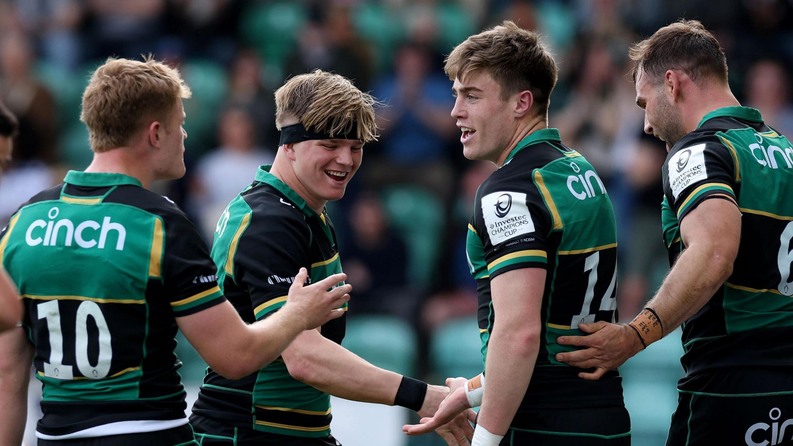 Northampton's Finn Smith, Henry Pollock and Tommy Freeman celebrate a try