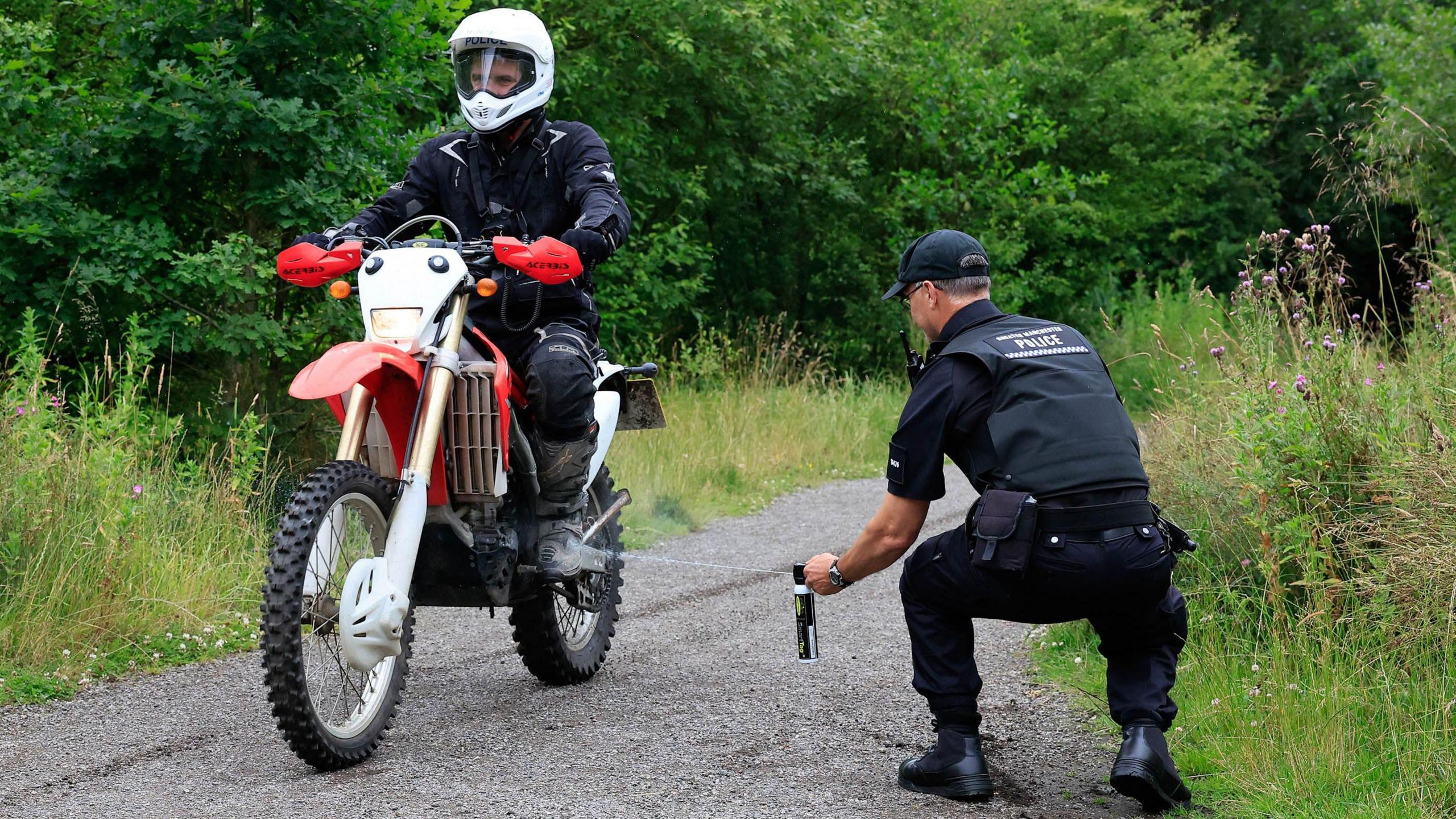 Police officer spraying bike 