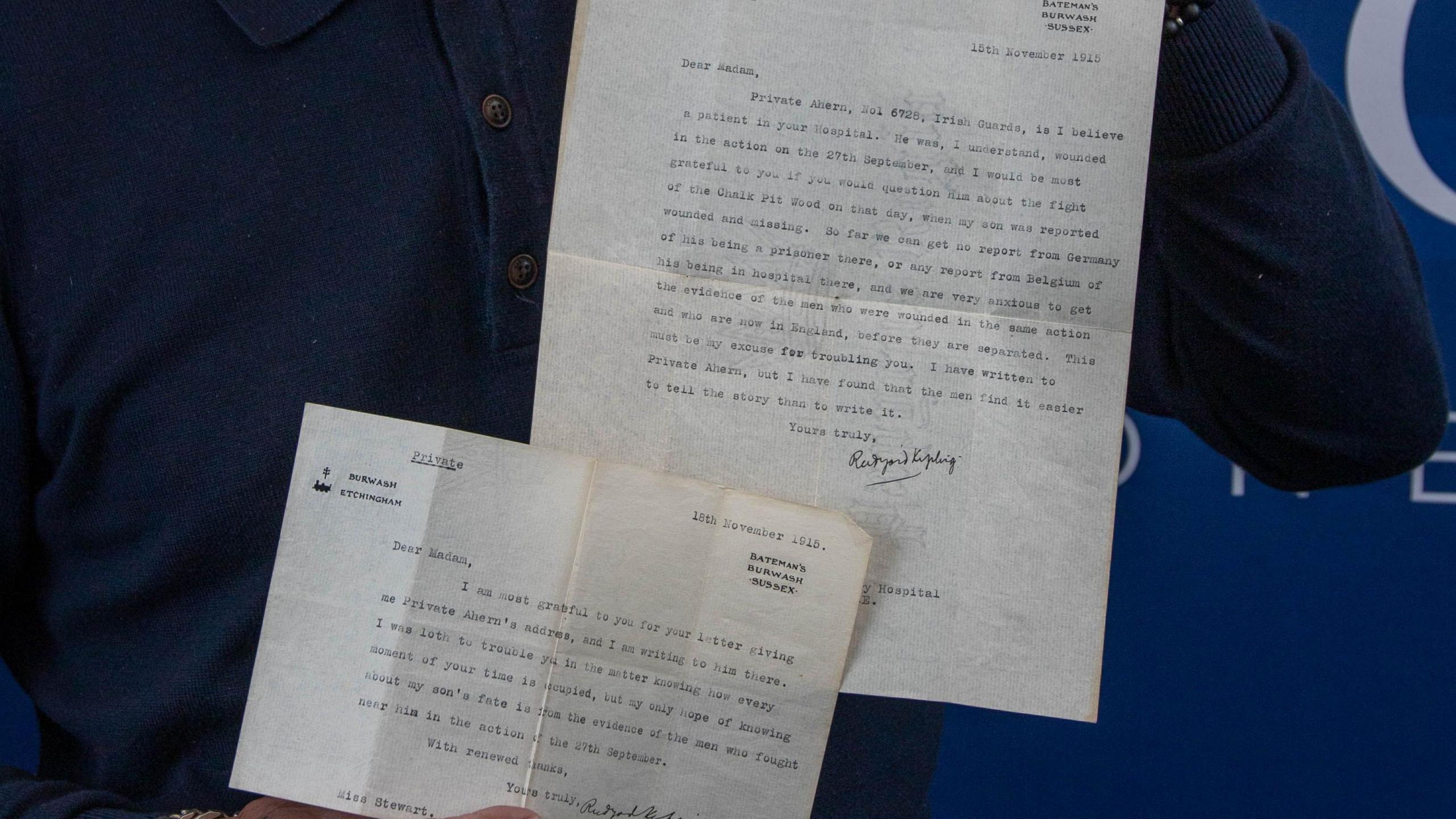Both letters being held up to camera