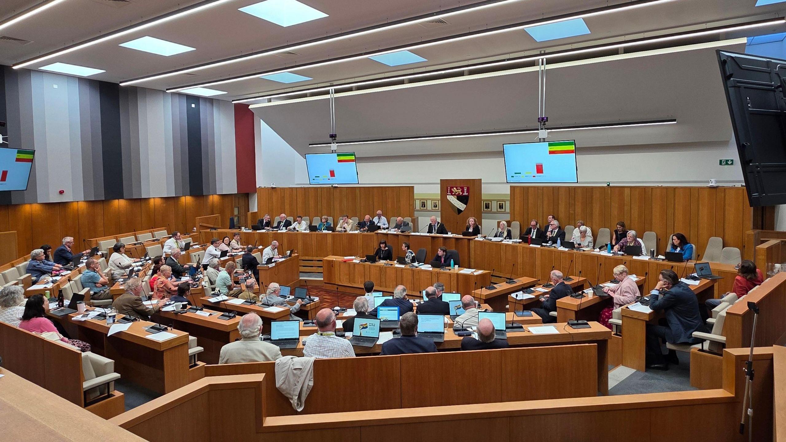 Councillors meeting in the council chamber at Norfolk County Hall