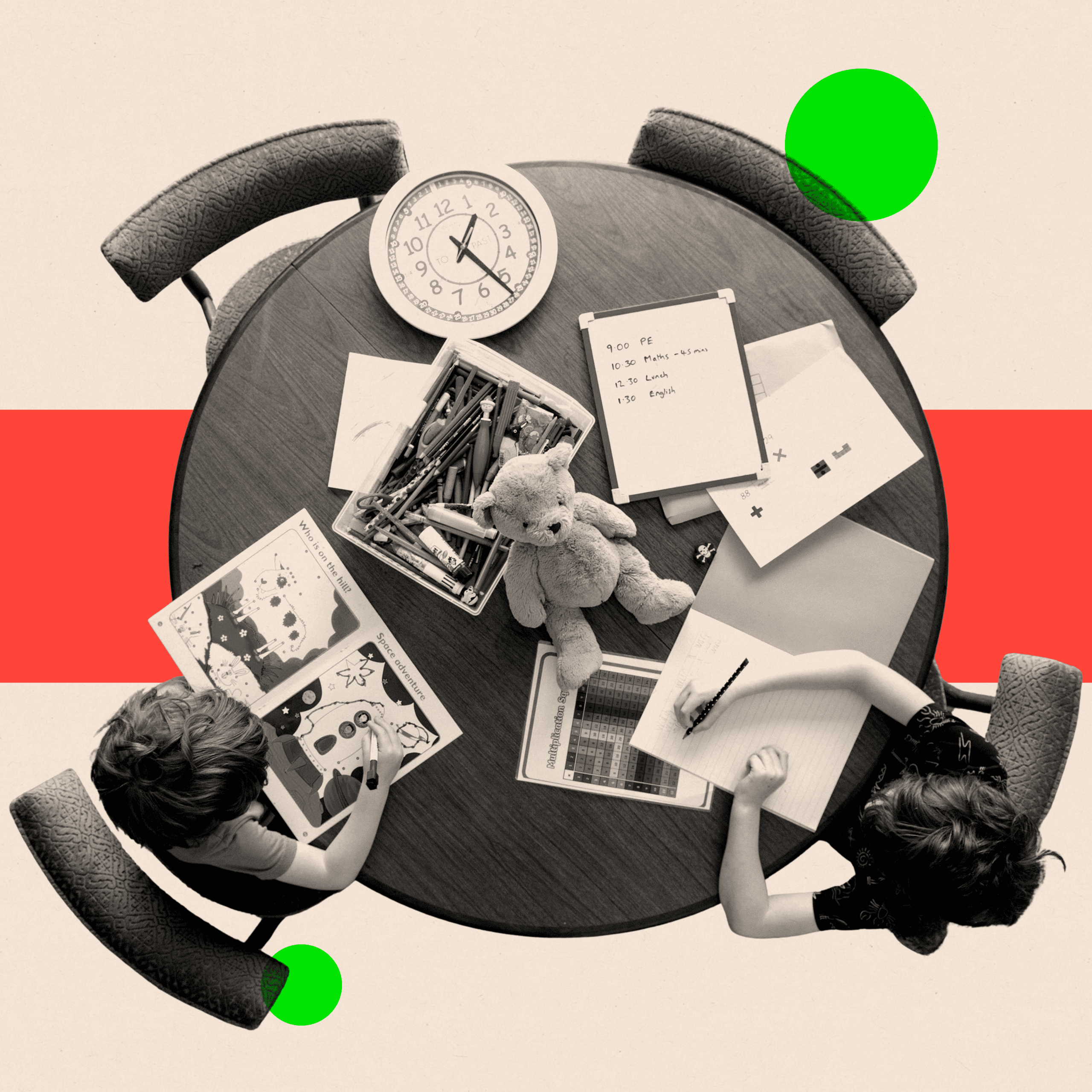 Two children sit around a circular table with textbooks, paper, a clock and a teddy bear