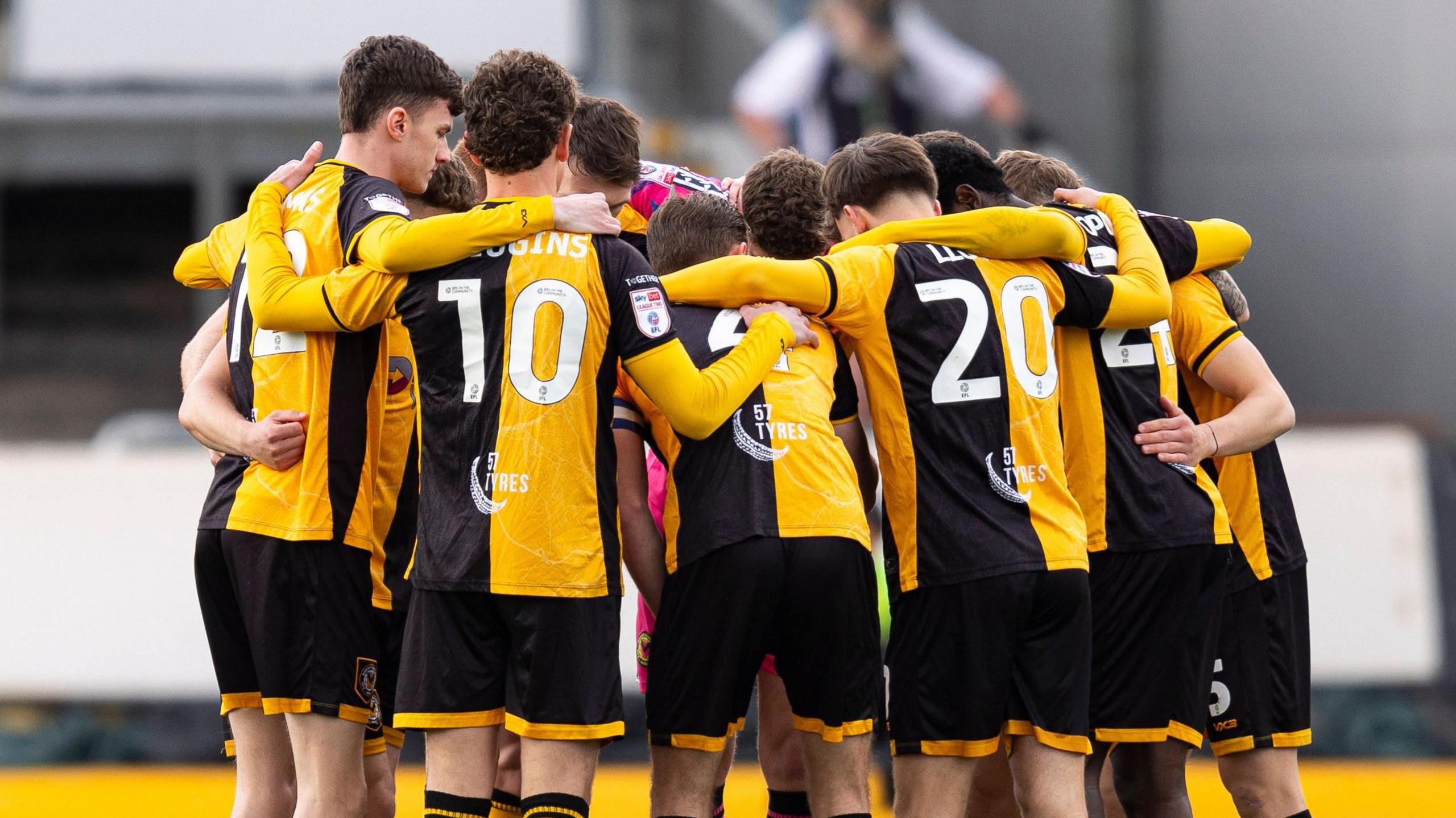 Newport County squad in a huddle before the game