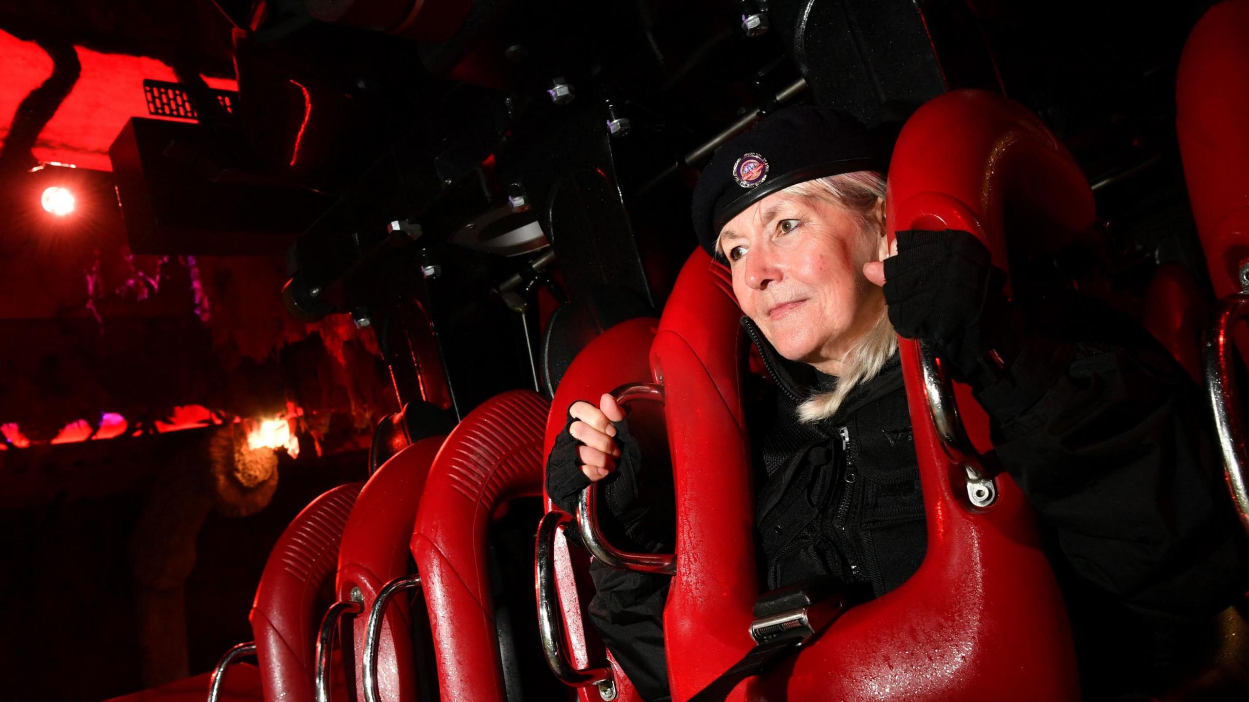 woman sitting in rollercoaster seat