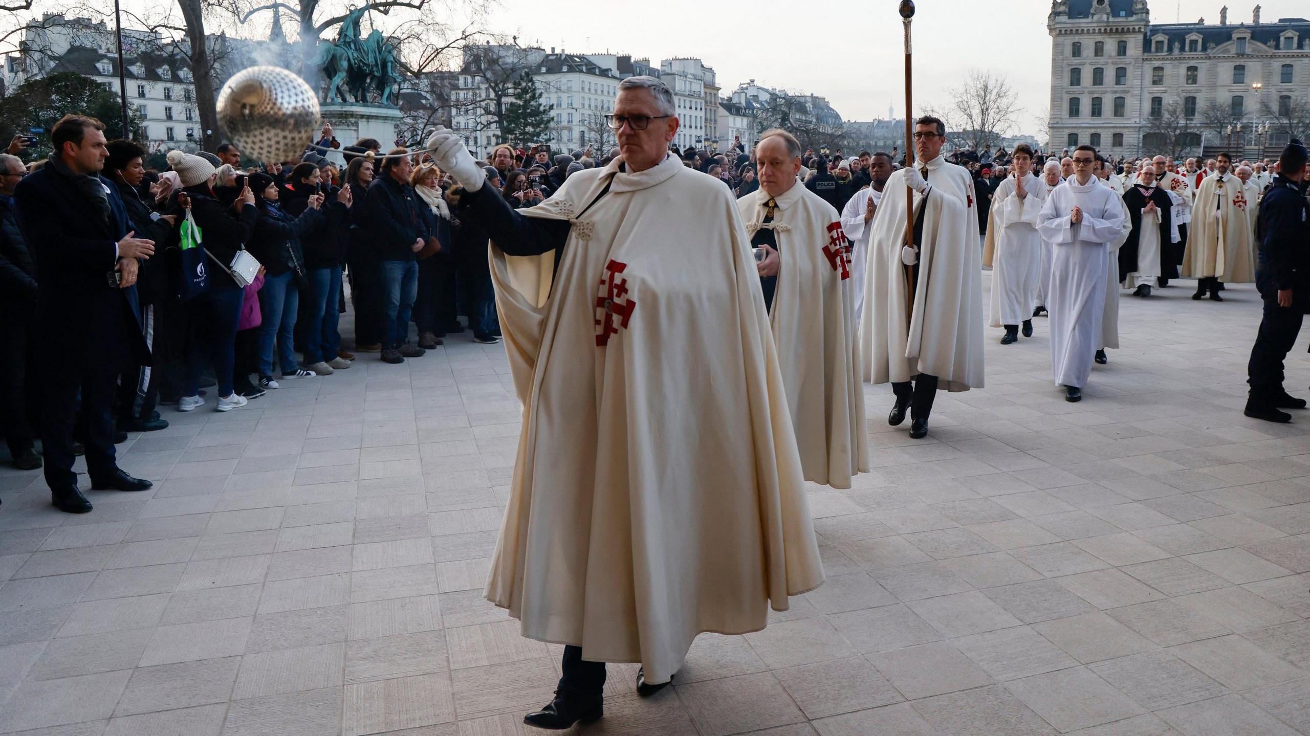 Knights of the Order of the Holy Sepulchre process towards the Notre-Dame Cathedral.