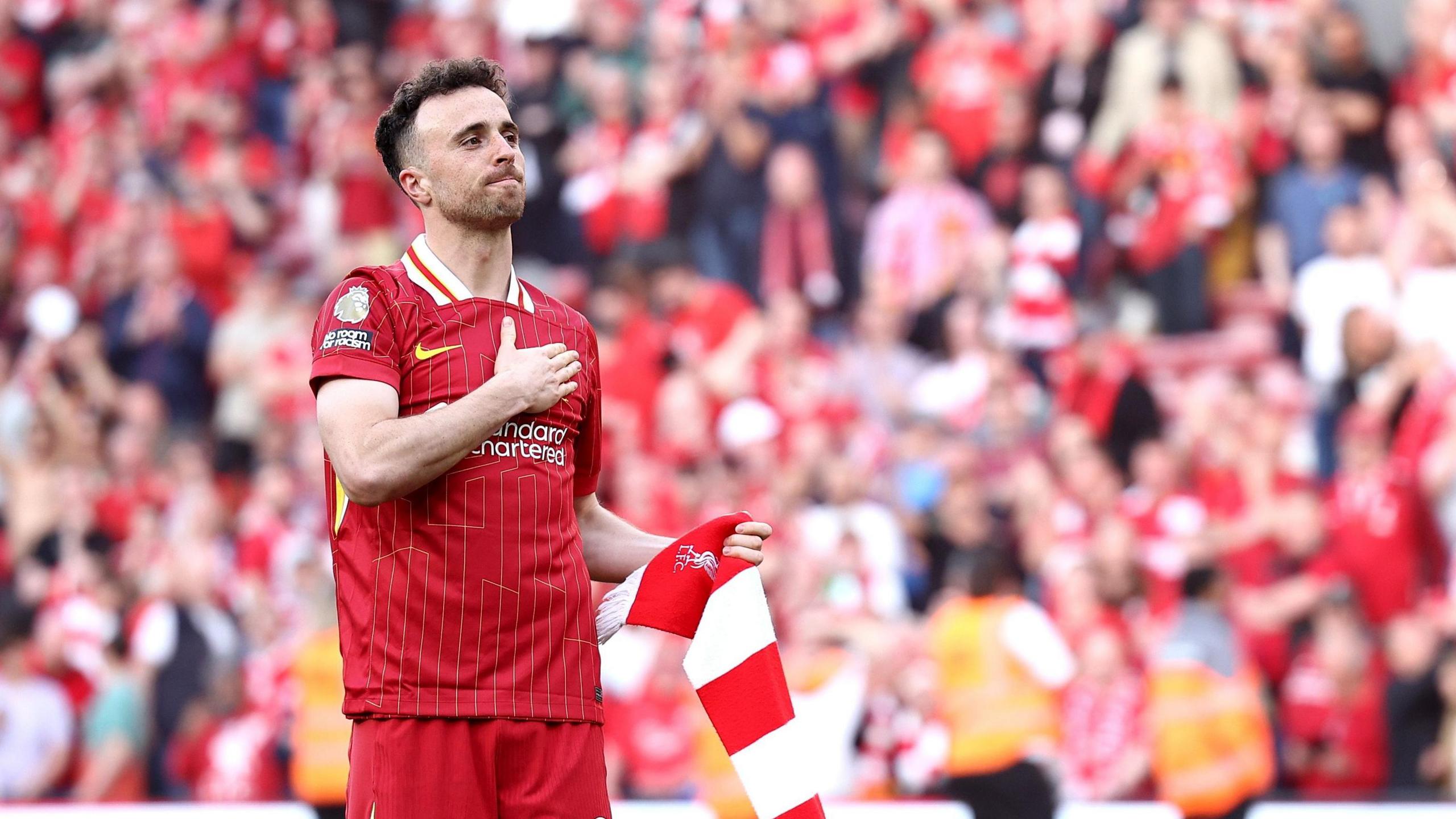 Diogo Jota gestures to Liverpool fans at Anfield with his hand on his chest