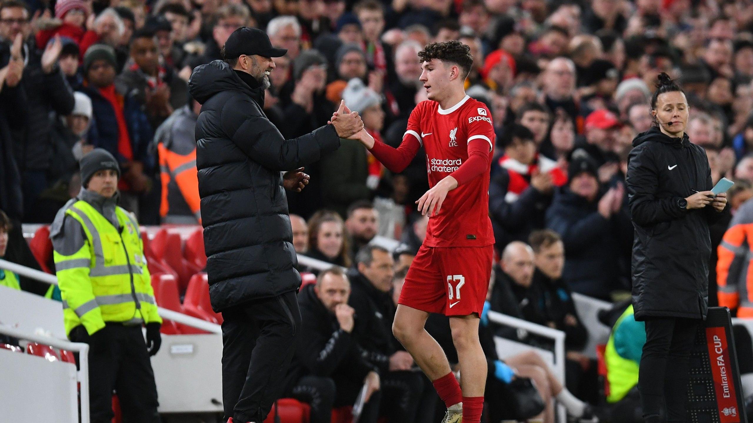 Jurgen Klopp shakes the hand of Lewis Koumas