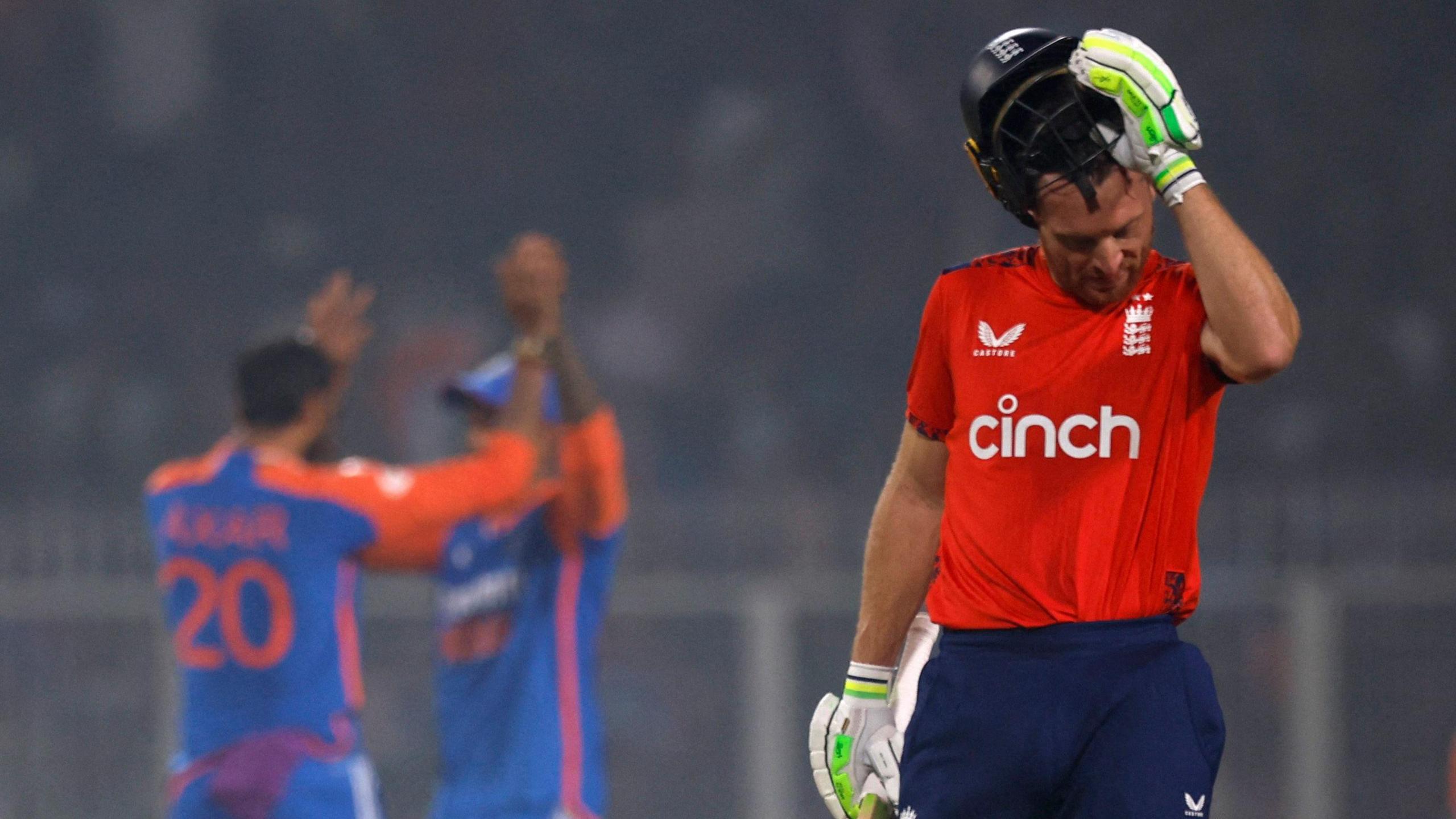 England captain Jos Buttler removes his helmet as he walks off after being dismissed