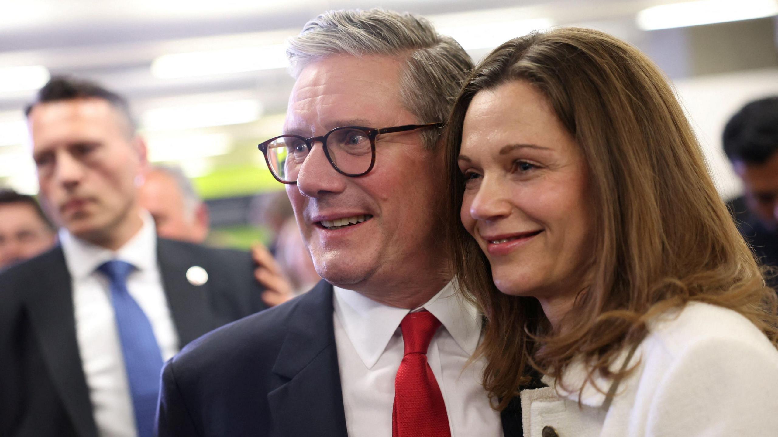 Keir Starmer and his partner Victoria Starmer smile for cameras