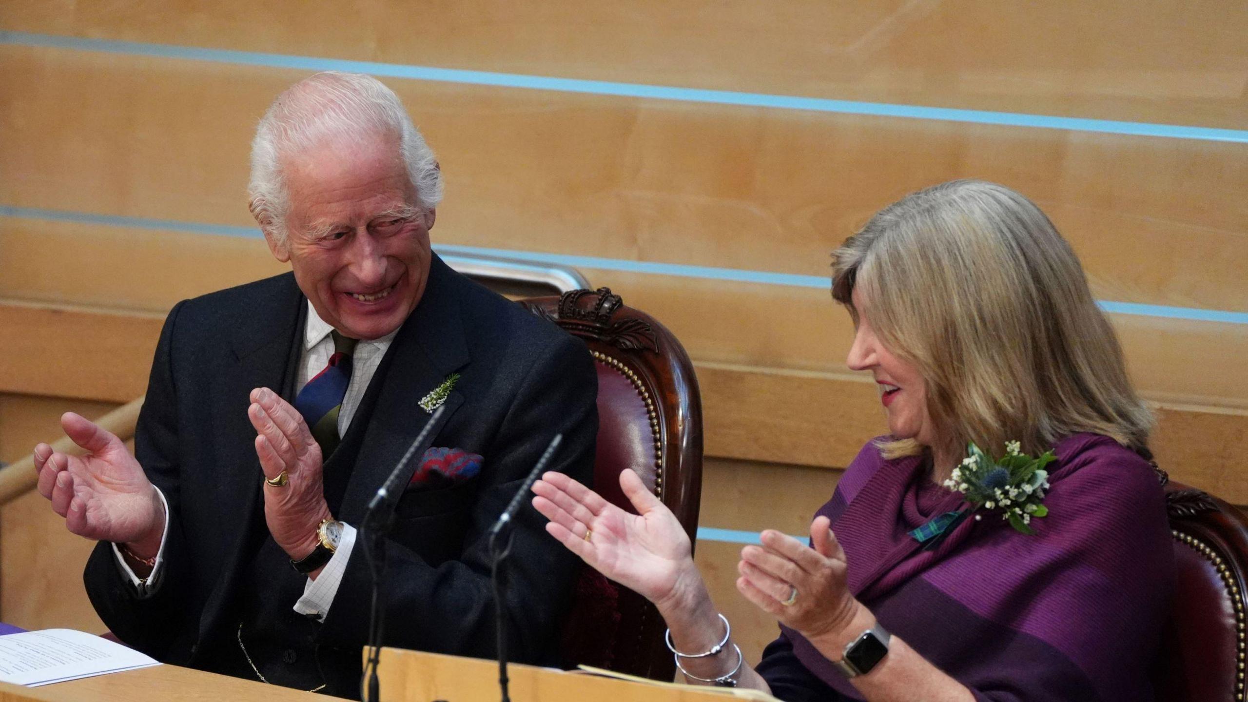 The King laughing and applauding with Presiding Officer Alison Johnstone