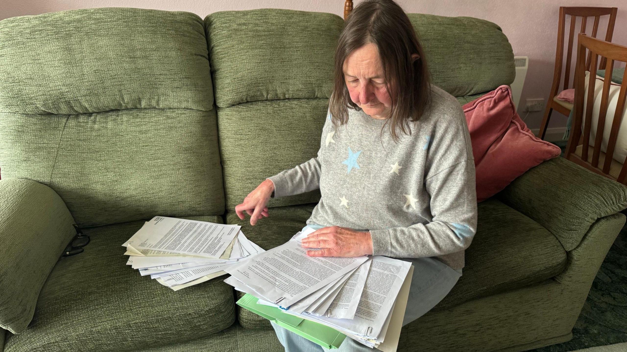 Diana Tasker going through print outs of letters she has written