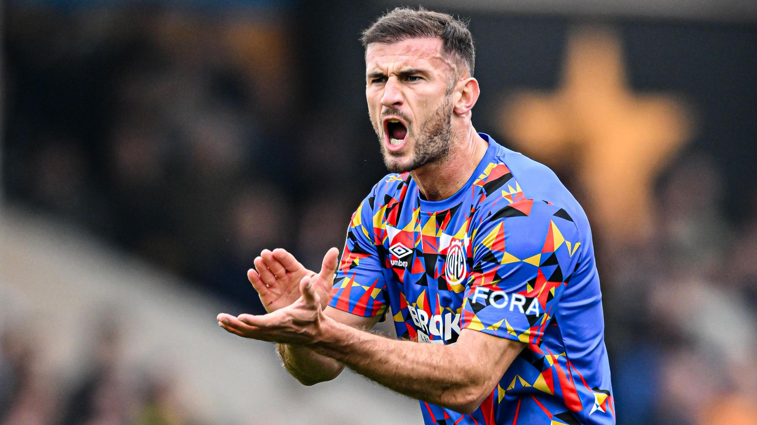 Dom Ball claps his hands to encourage his Cambridge team-mates