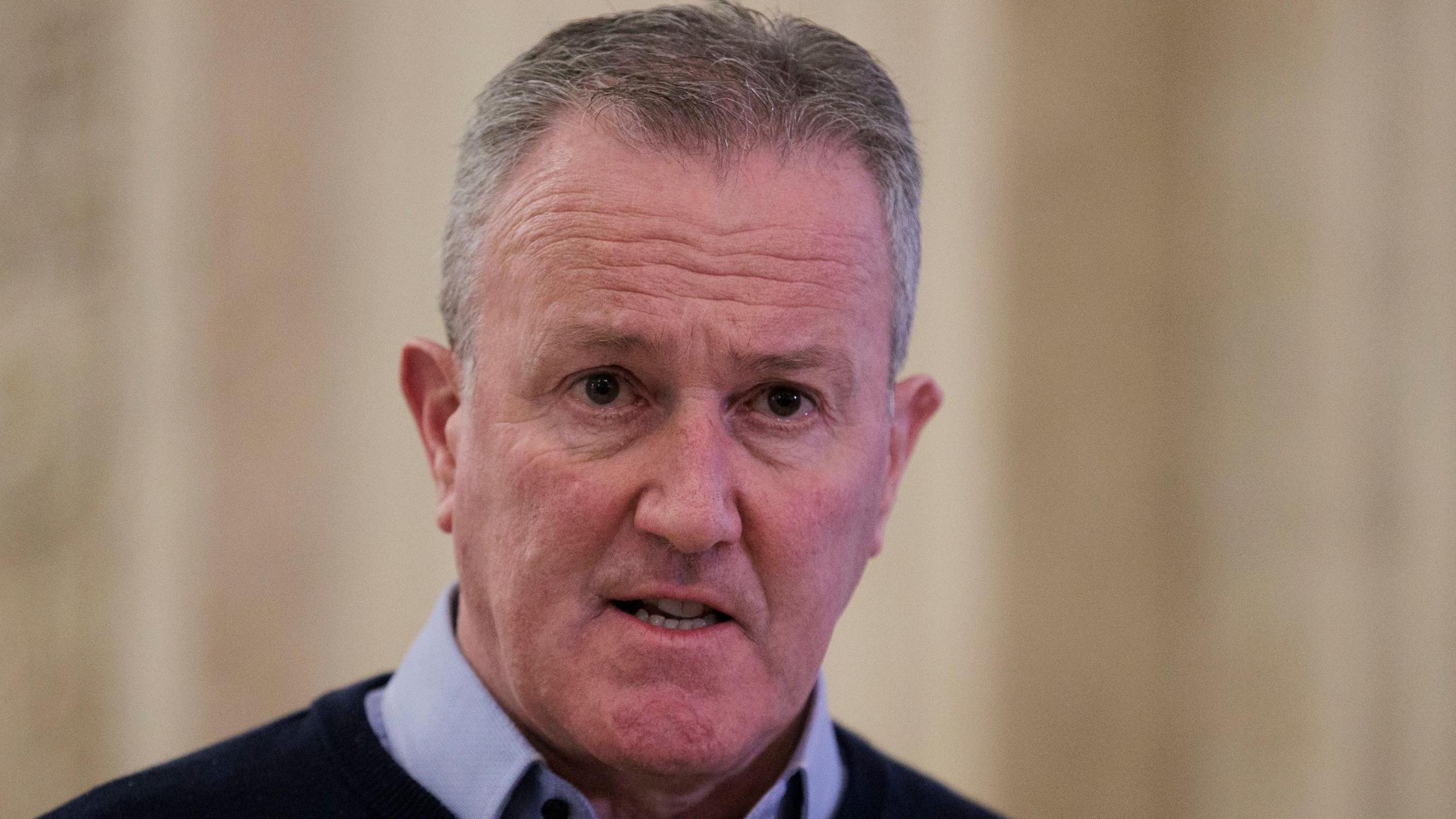 Stormont's economy minister Conor Murphy, wearing a blue shirt and a navy jumper. 