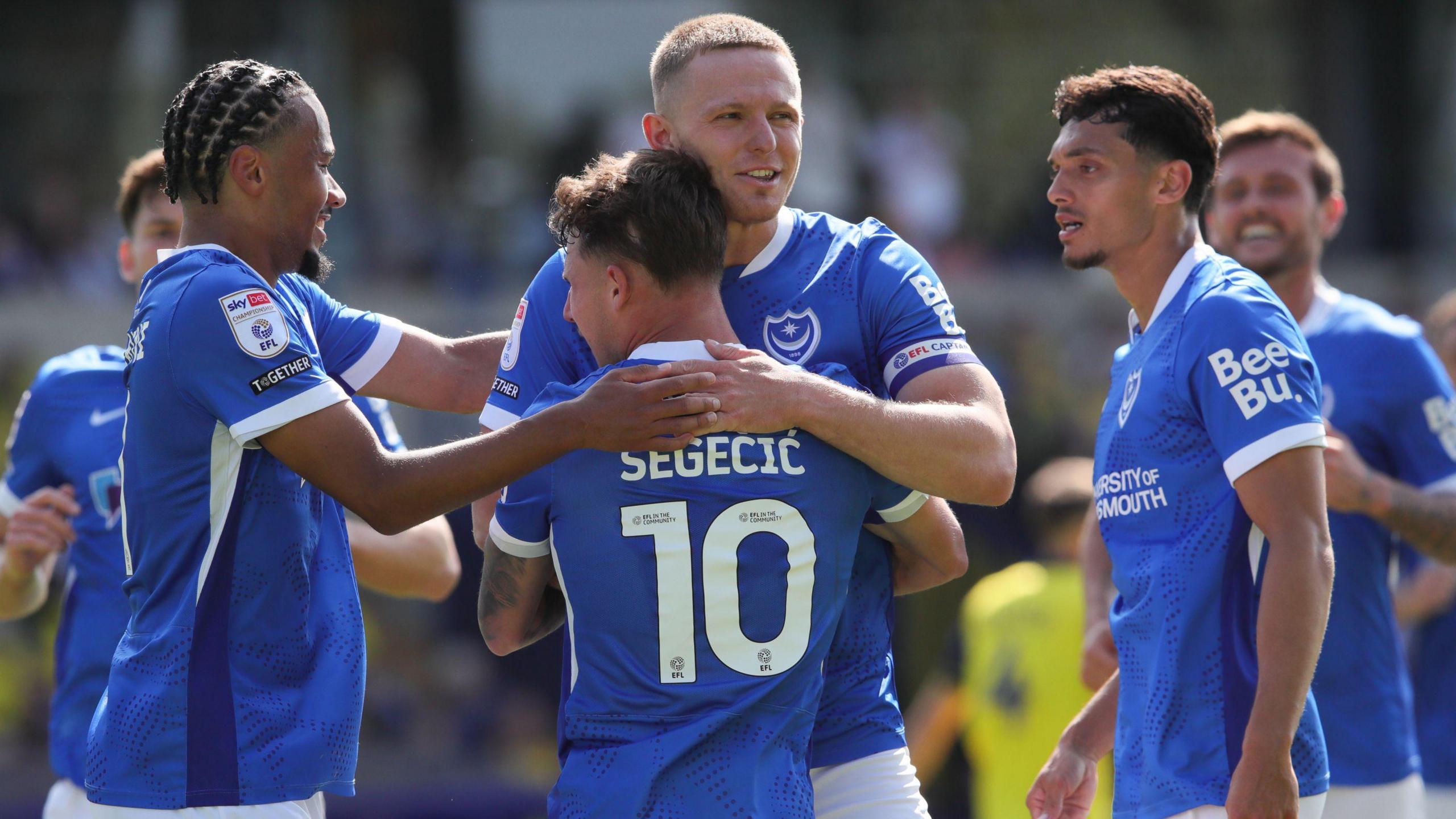 Portsmouth players celebrate their first goal during the Championship match between Oxford United and Portsmouth at the Kassam Stadium