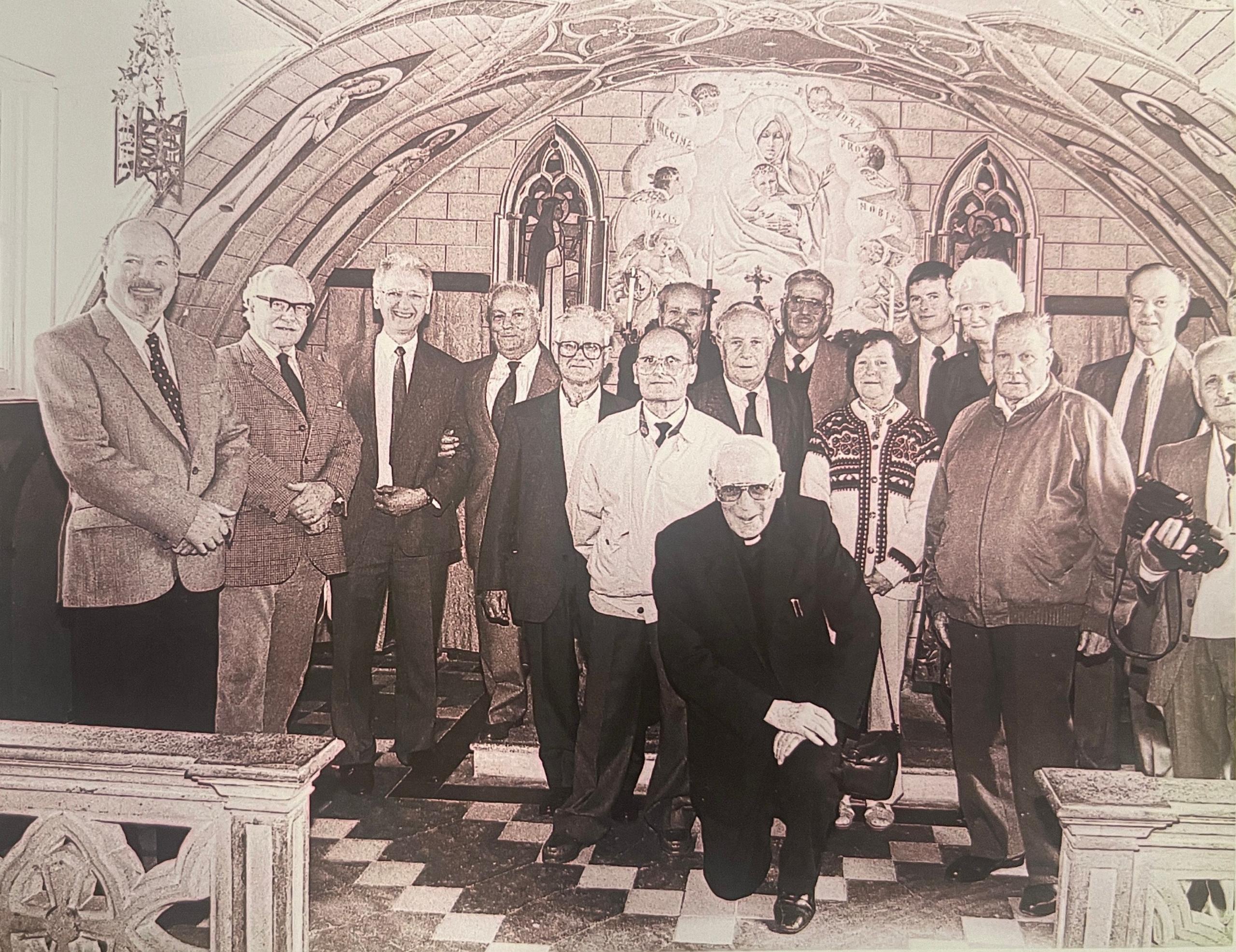 A black and white picture of a group of men and women inside the castle. It was clearly taken several years ago.