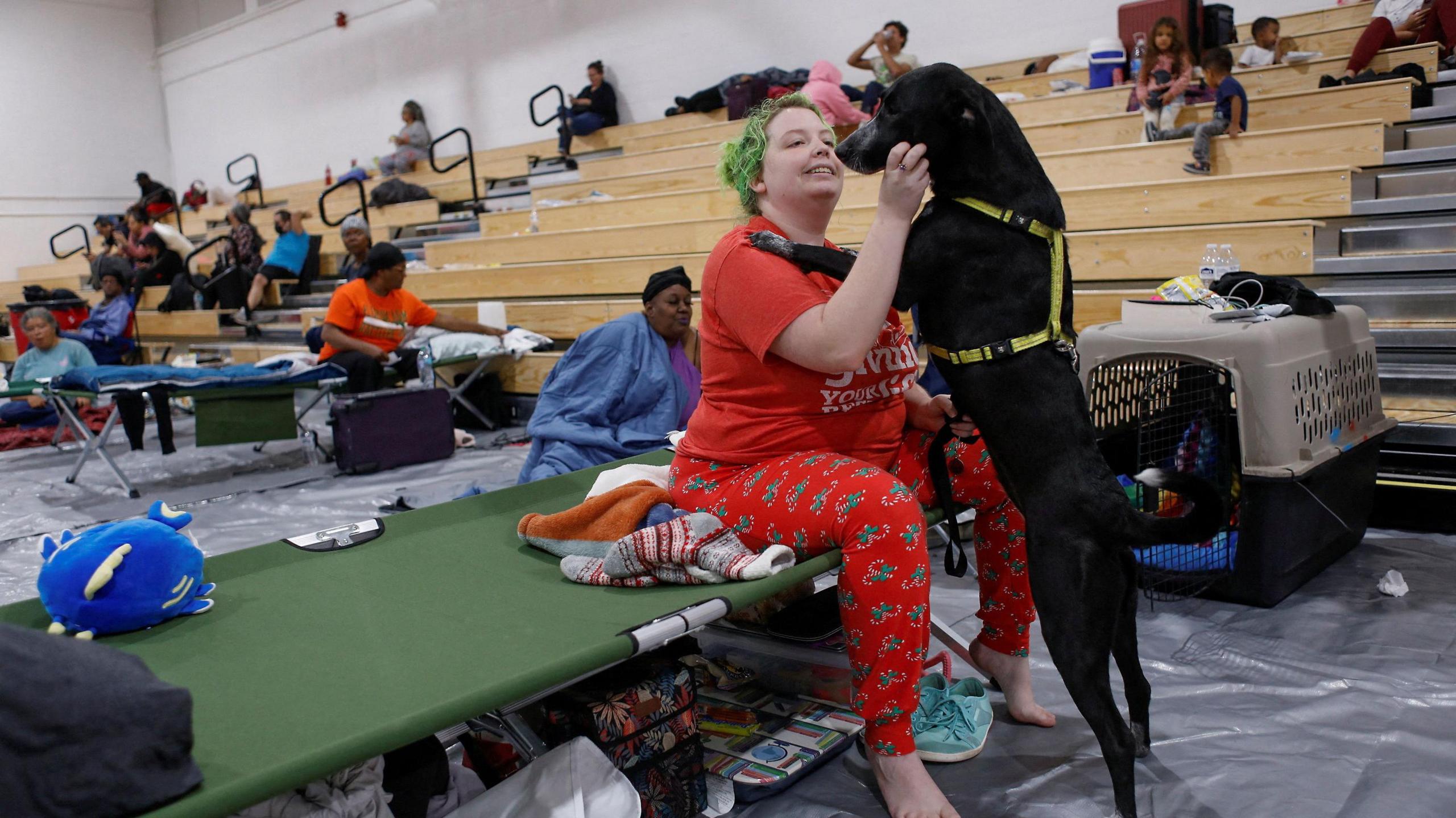 Amber Hardin, 27, spends time with her dog Ducky while taking shelter from Hurricane Helene at Leon High School near downtown Tallahassee, Florida 