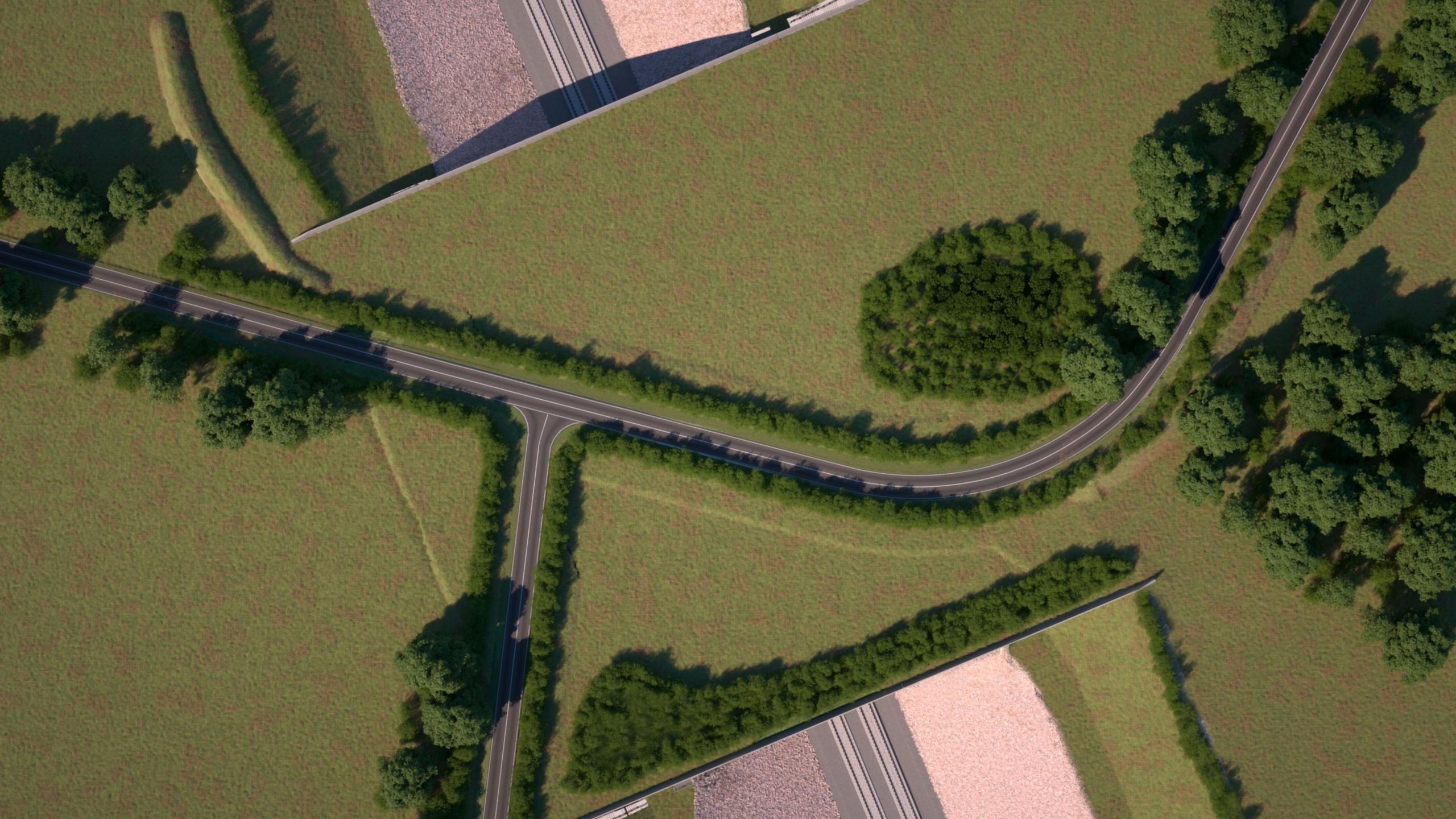 A computer-generated image shows a bird's eye view of a green bridge carrying a road and covered in tress and grass over the top of a train line 