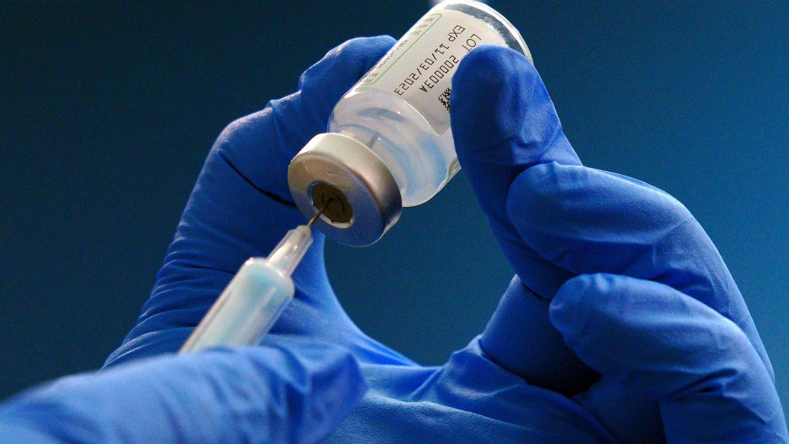 A hand holding a medical bottle.