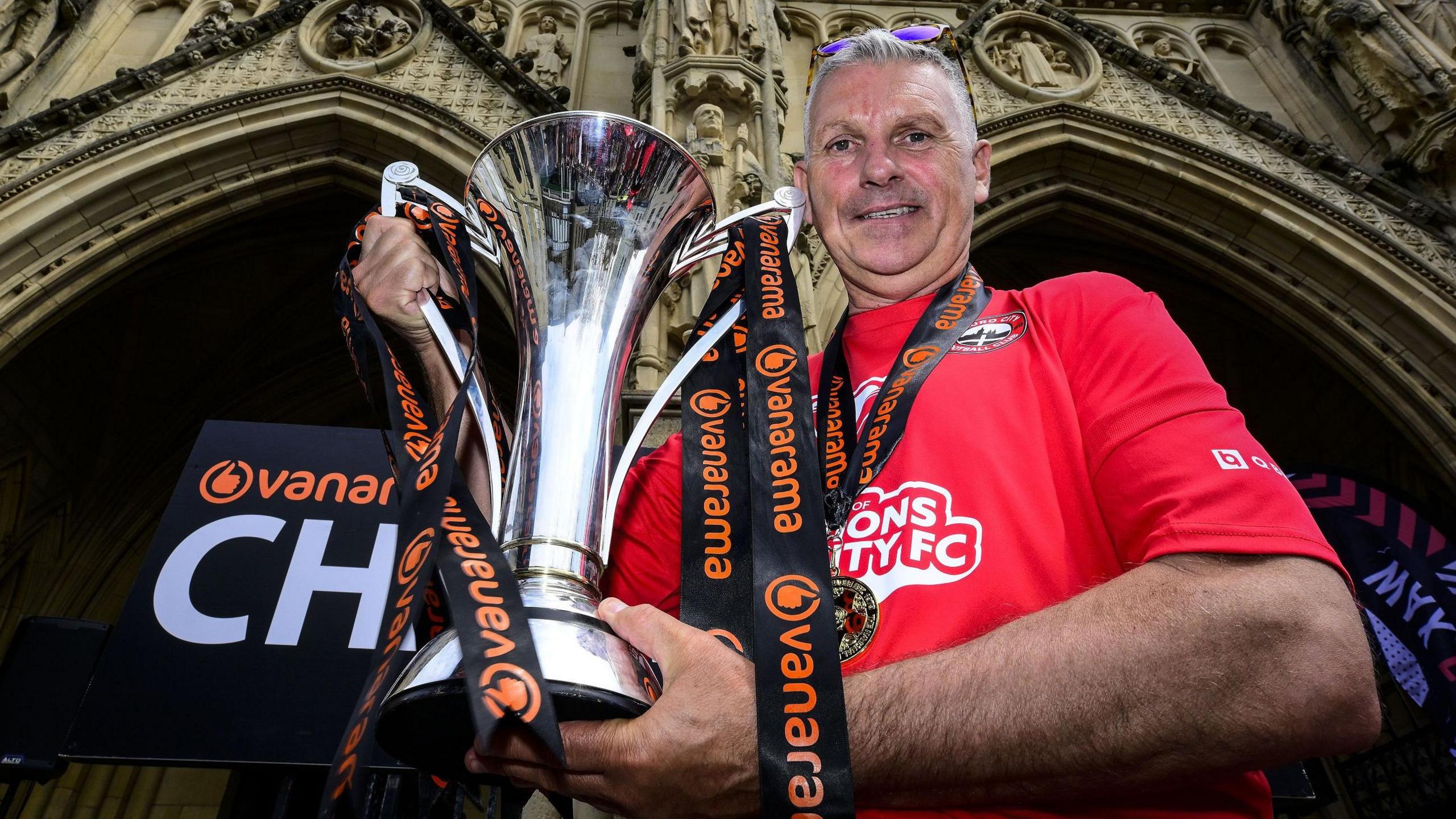 John Askey poses with the National League South trophy