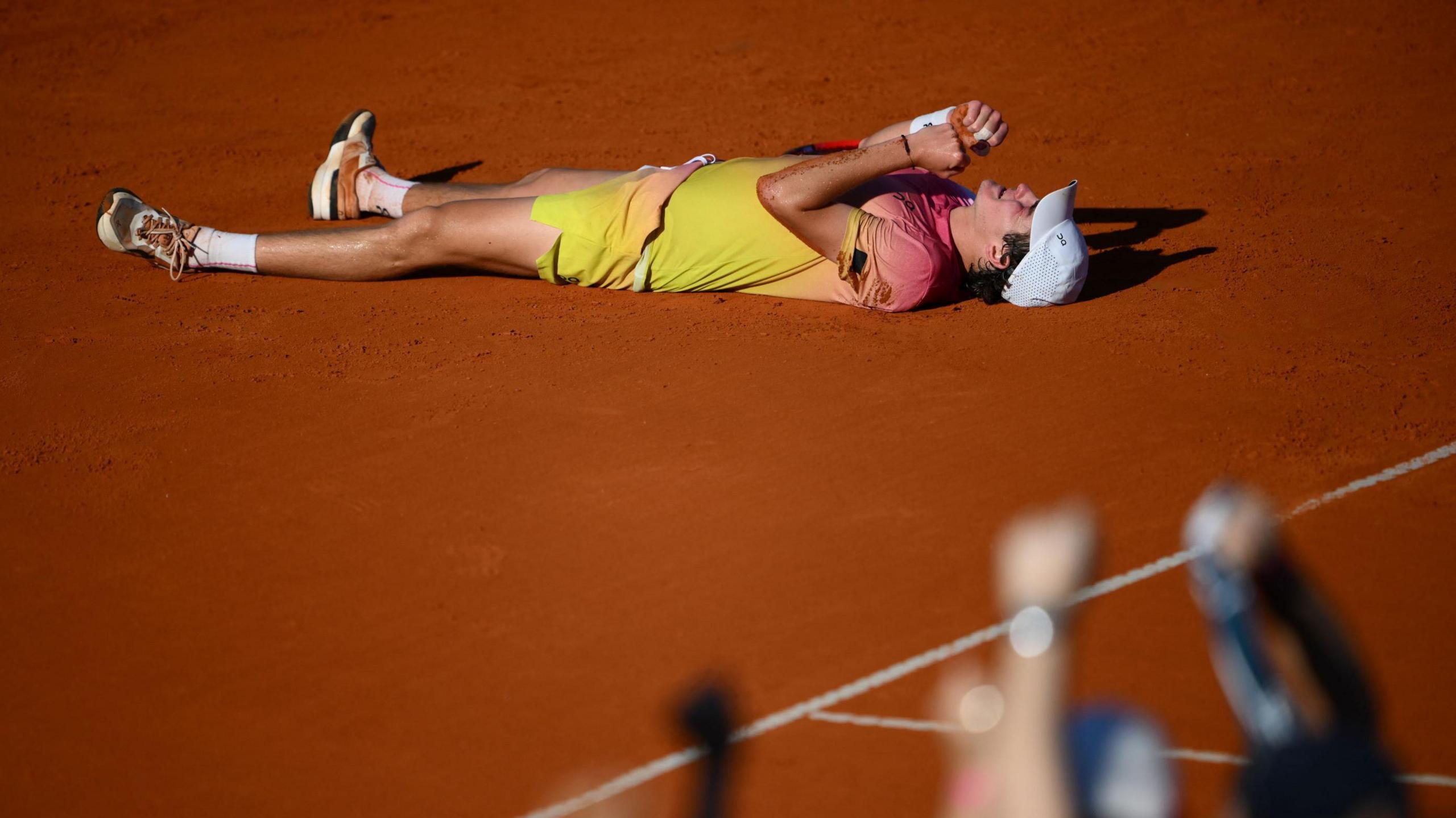 Joao Fonseca lays out on the Buenos Aires clay after winning the title