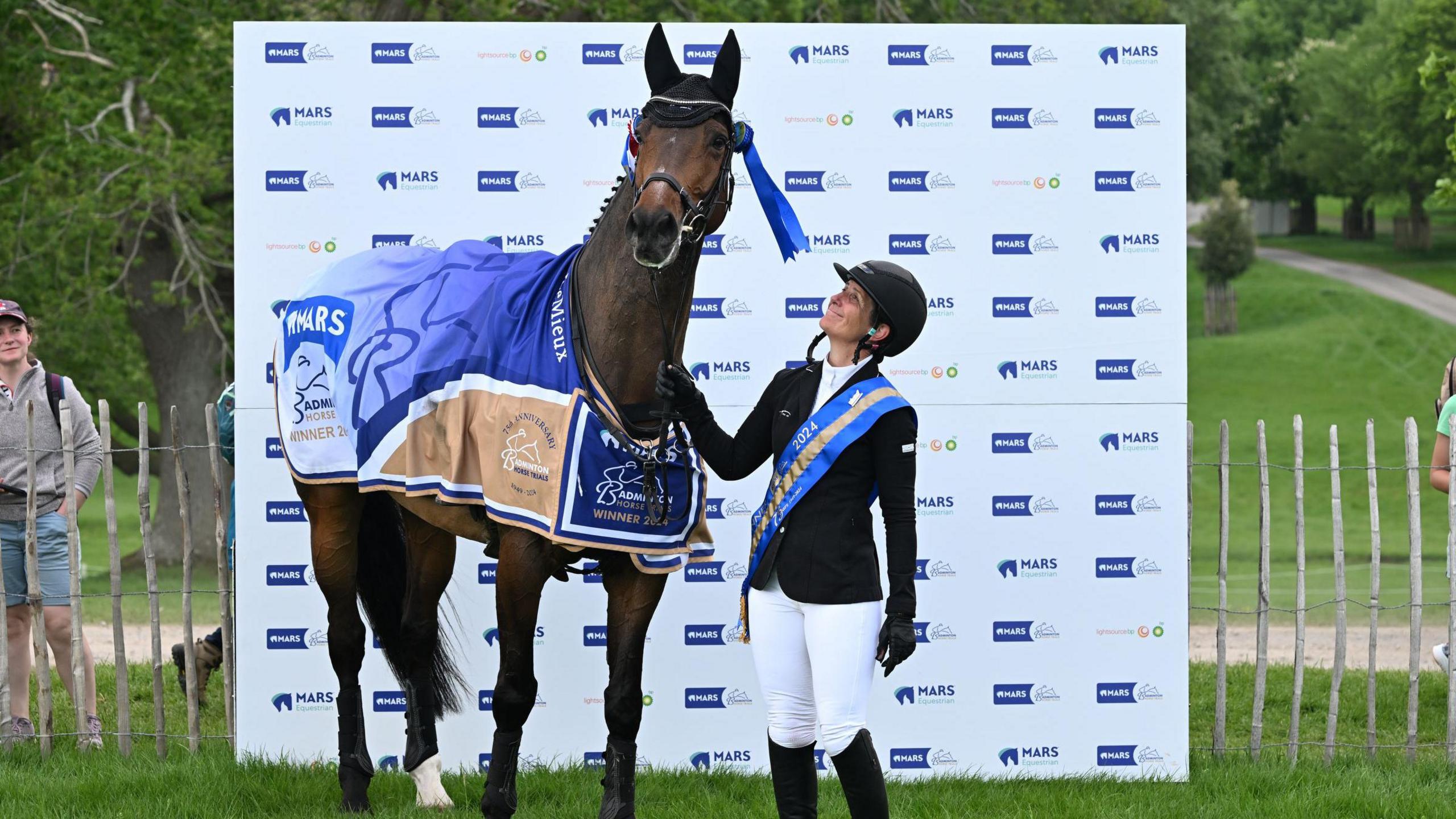 Caroline Powell from the New Zealand team at the winners stand with her brown bay horse Greenacres Special Cavalier looking rather pleased with himself.