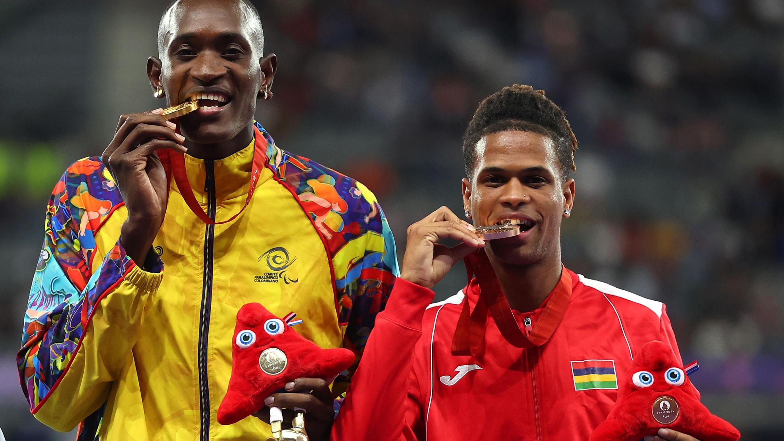 Jhon Sebastian Obando Asprilla of Colombia and Yovanni Philippe of Mauritius pose with their gold and bronze medals respectively on the podium at Paris 2024